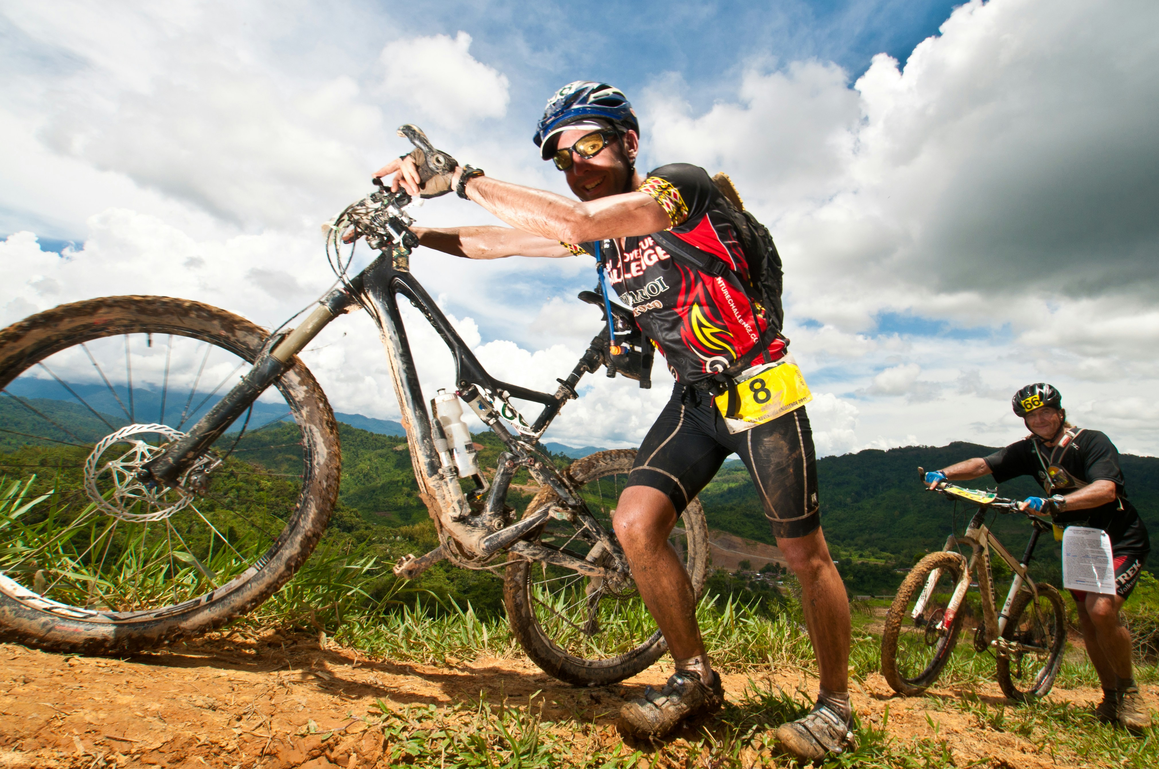 A man riding a bike down a dirt road
