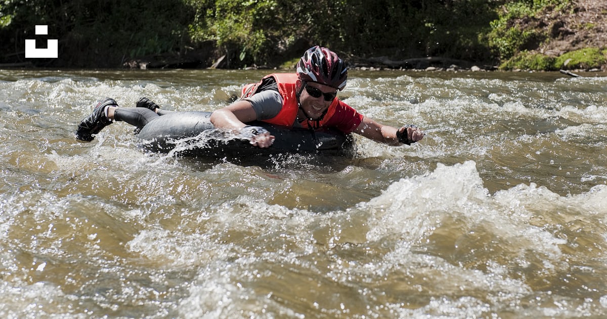 A man riding a raft down a river photo – Free Adventure Image on Unsplash