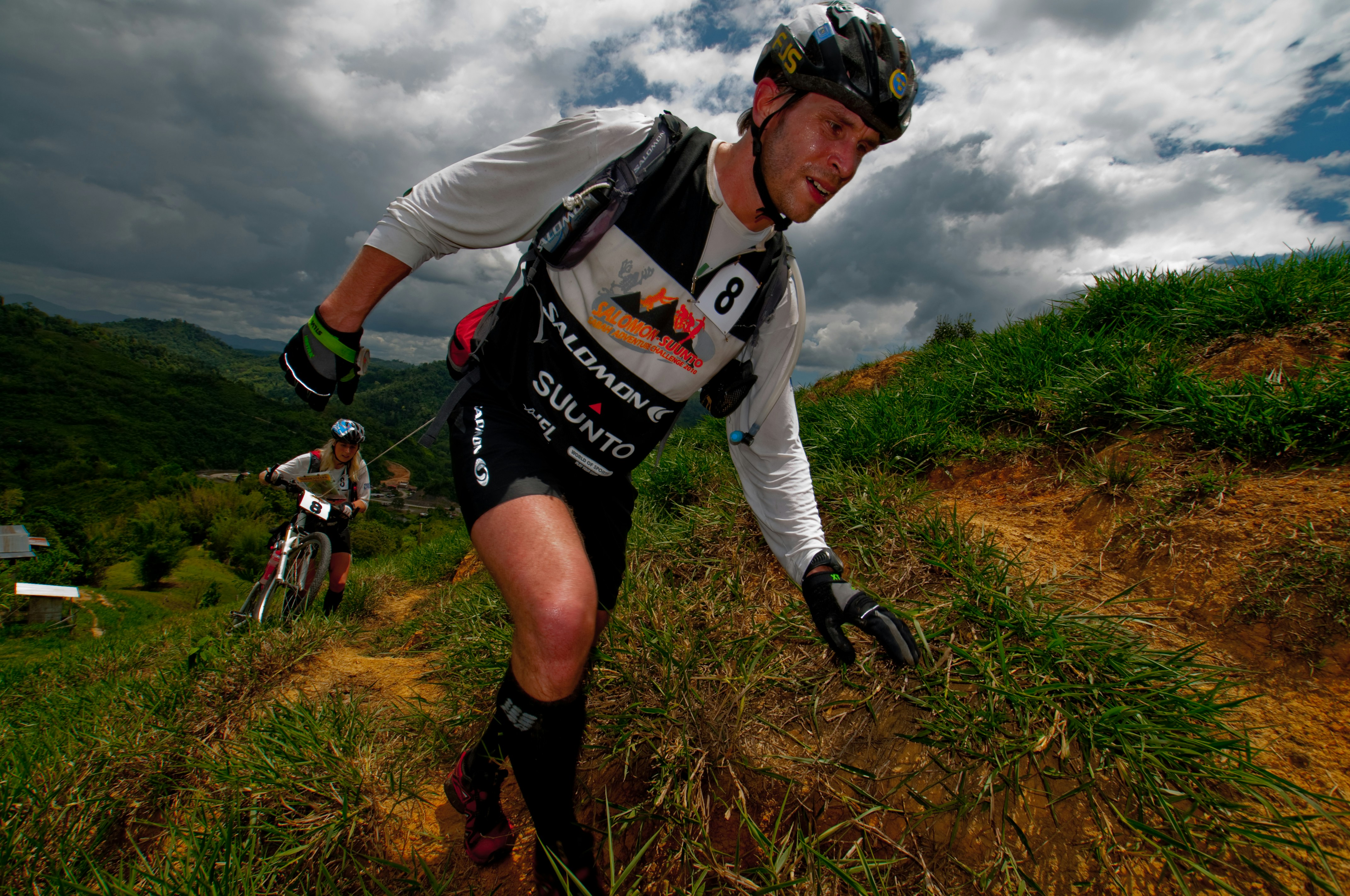 A man riding a bike down a dirt road