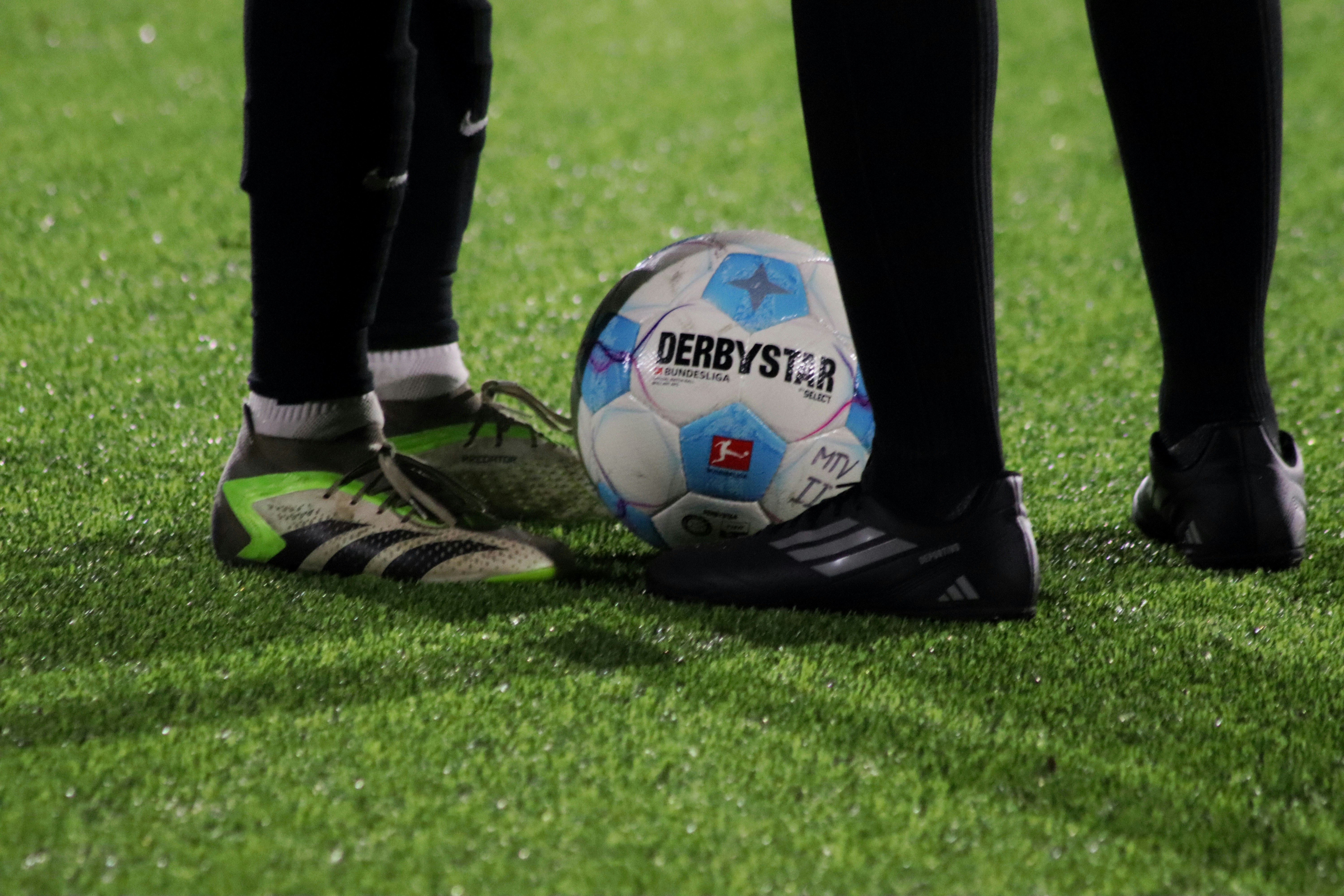 A soccer ball sitting on top of a lush green field