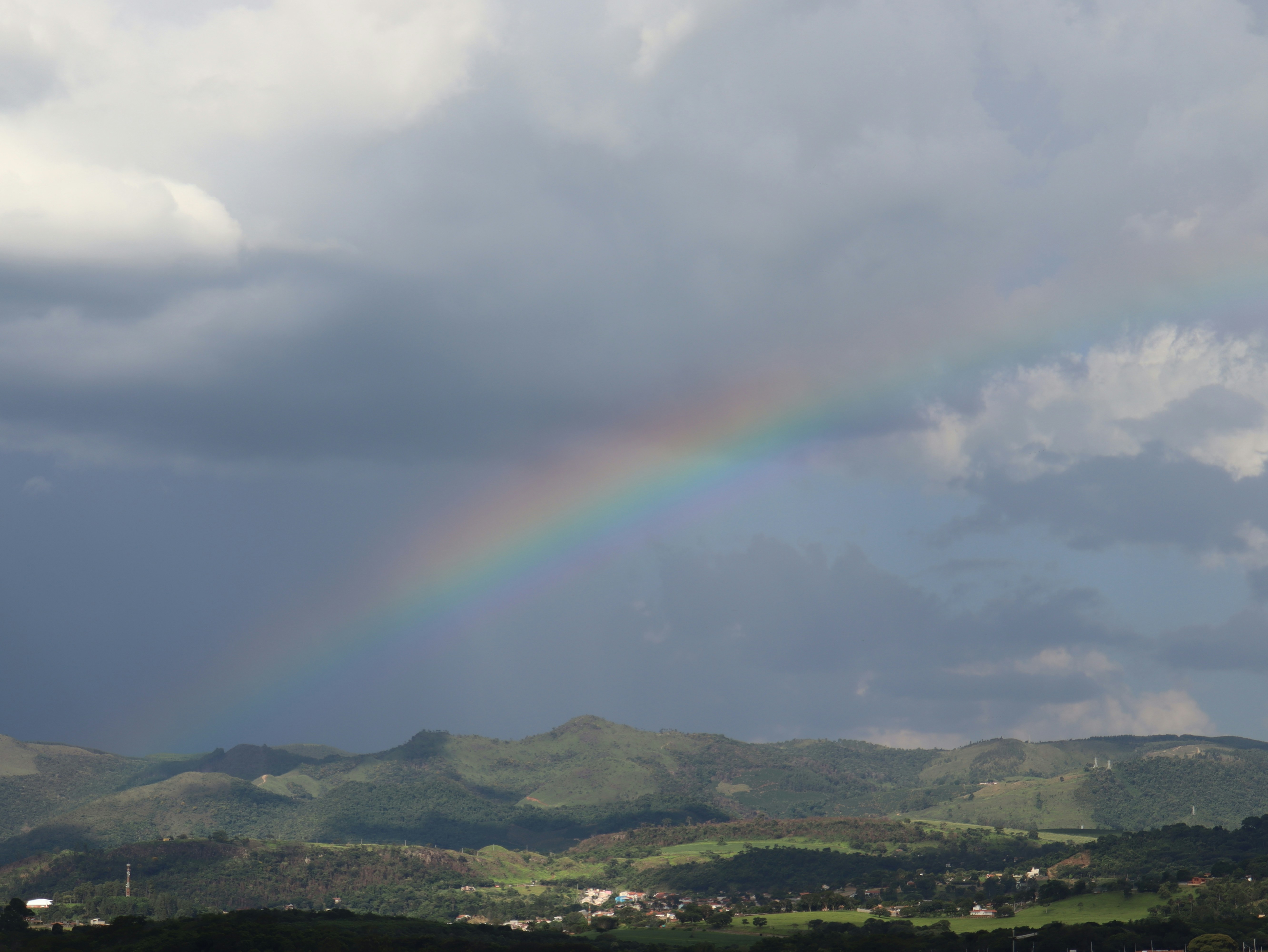 A rainbow in the sky over a green field