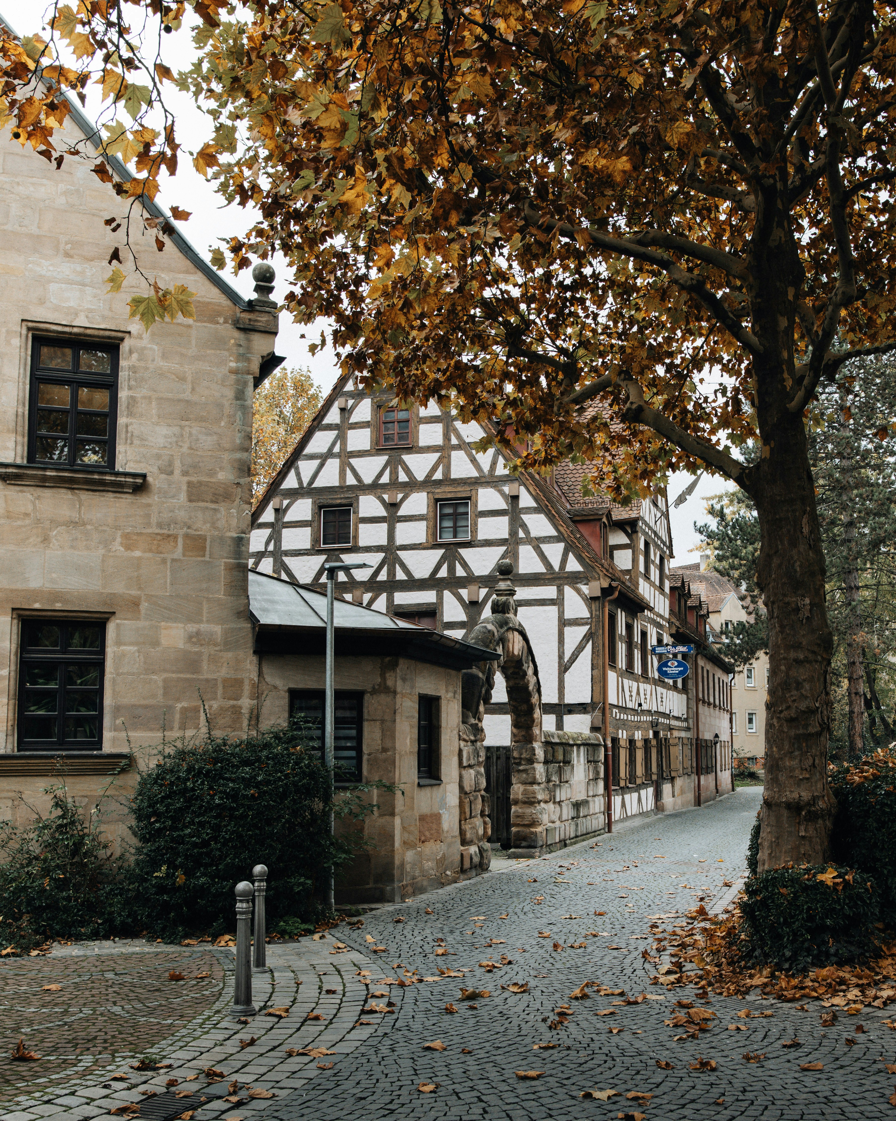 A cobblestone street with a building in the background