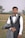 A man in a tuxedo standing in a field