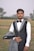A man in a tuxedo standing in a field