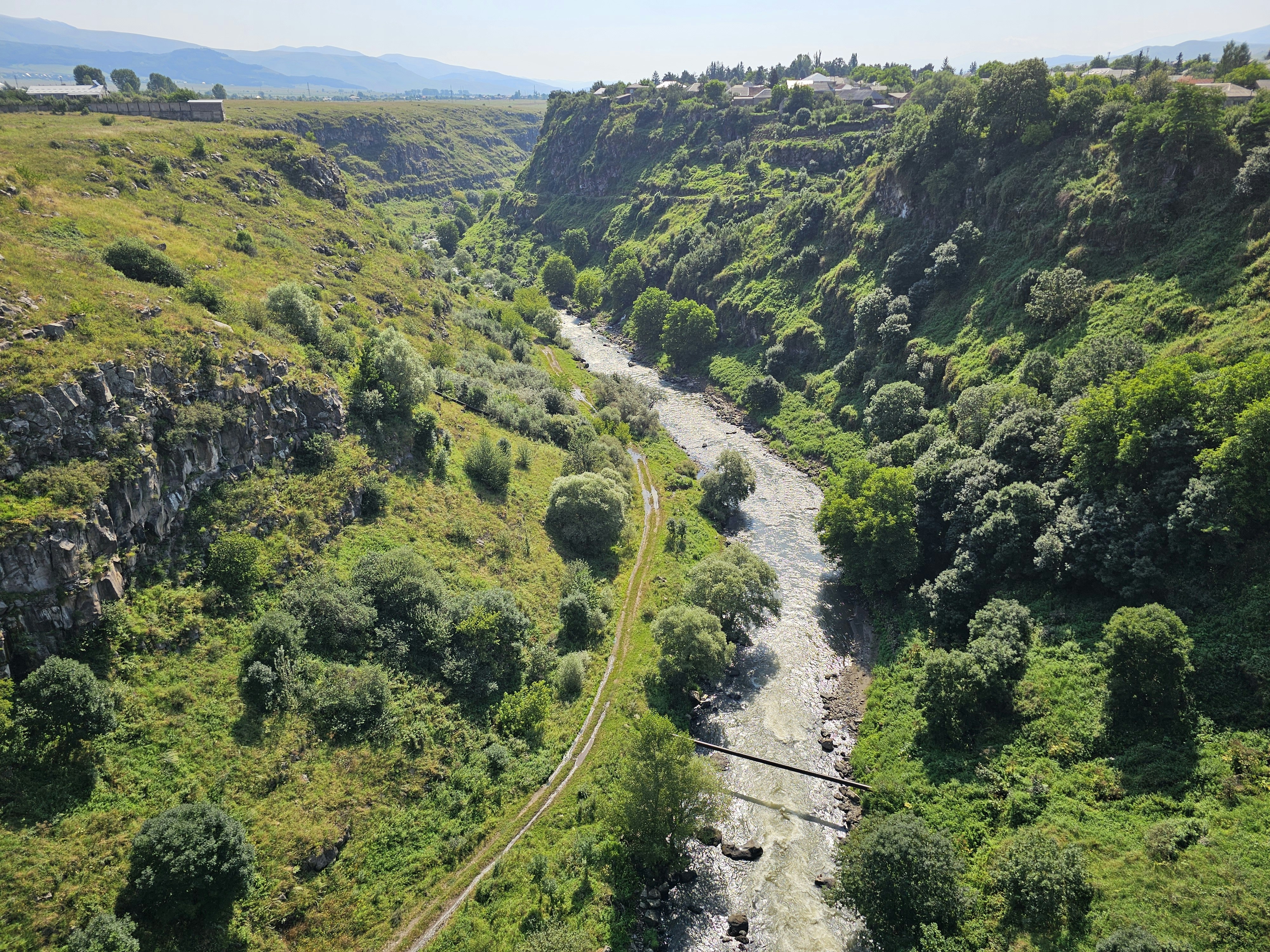 A river running through a lush green valley