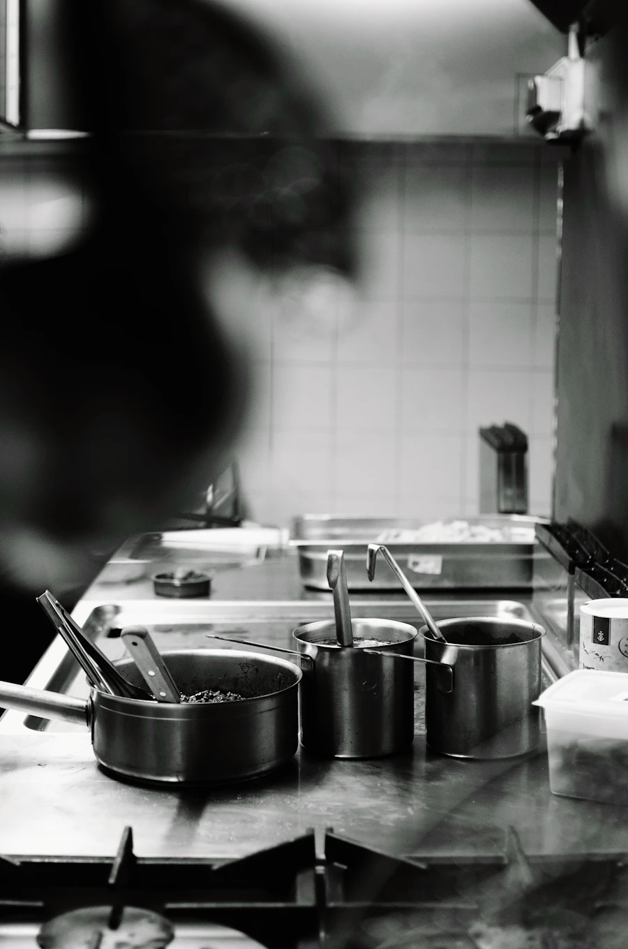 Cook preparing food at a restaurant stove