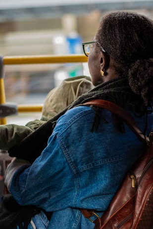 A woman sitting on a bus with a child on her lap