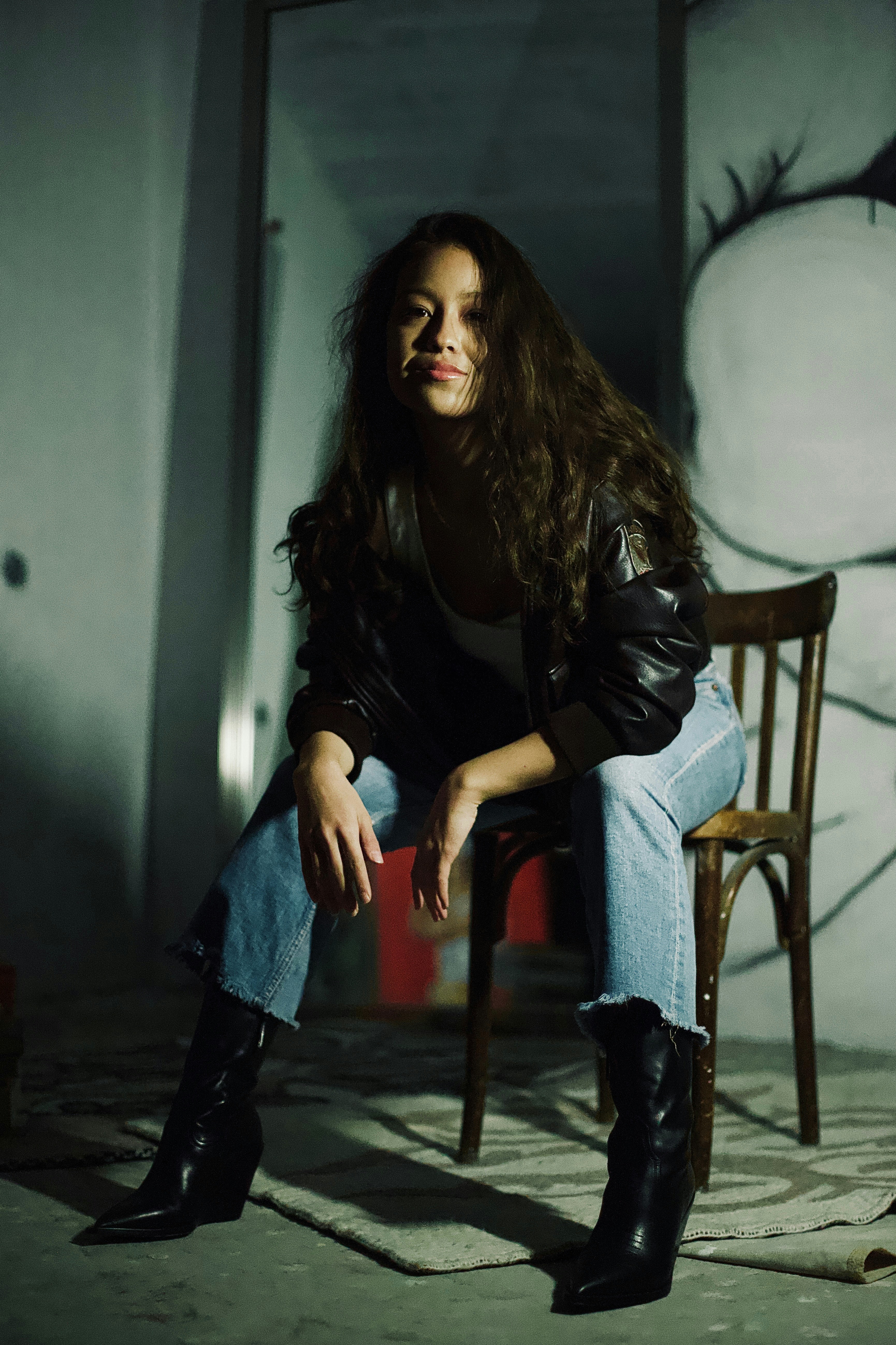 A woman sitting on a chair in front of a snowman