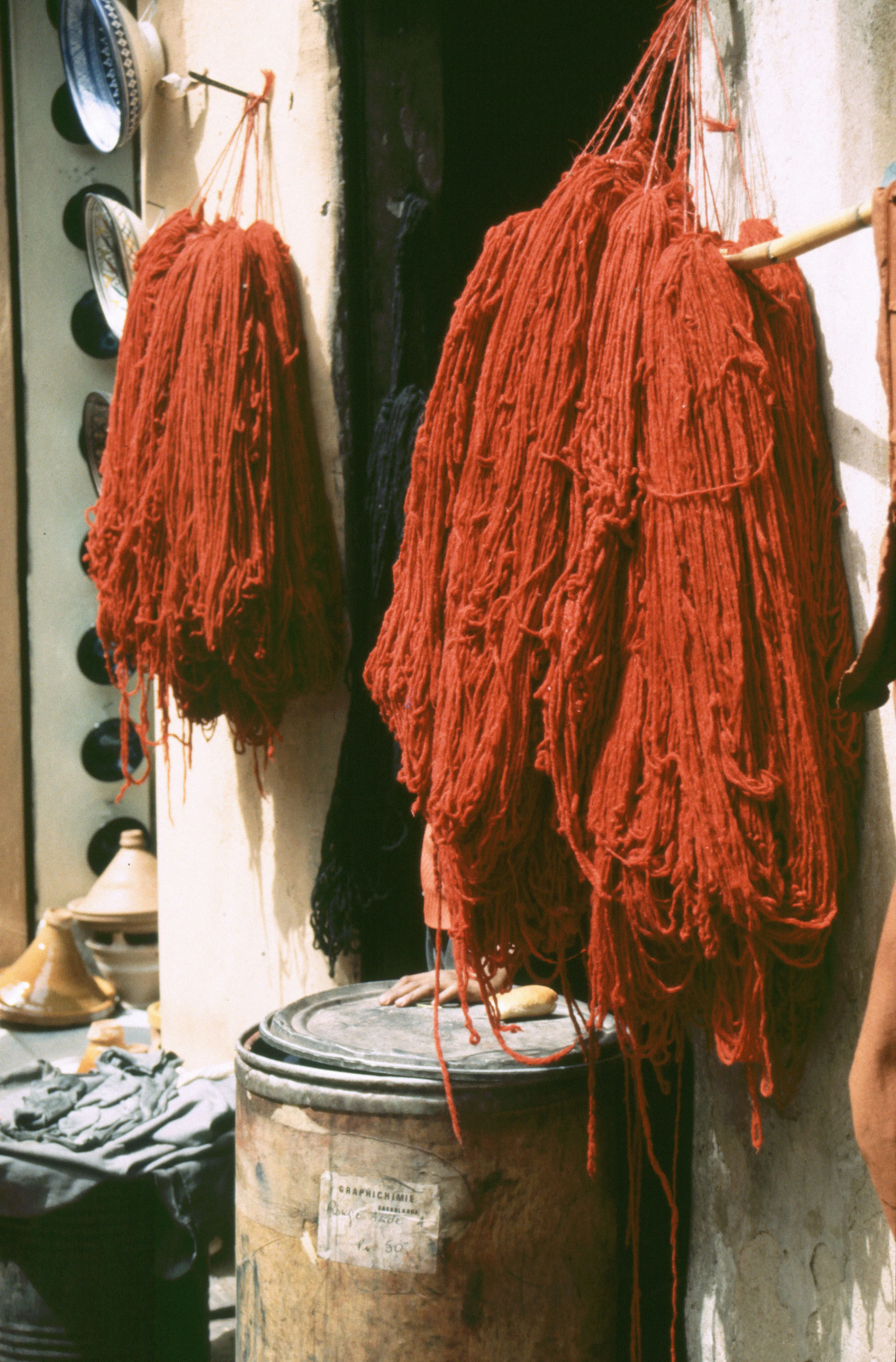 Bundles of red dyed wool hanging to dry in the Marrakech medina