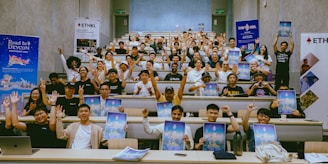 A group of people sitting at desks with laptops