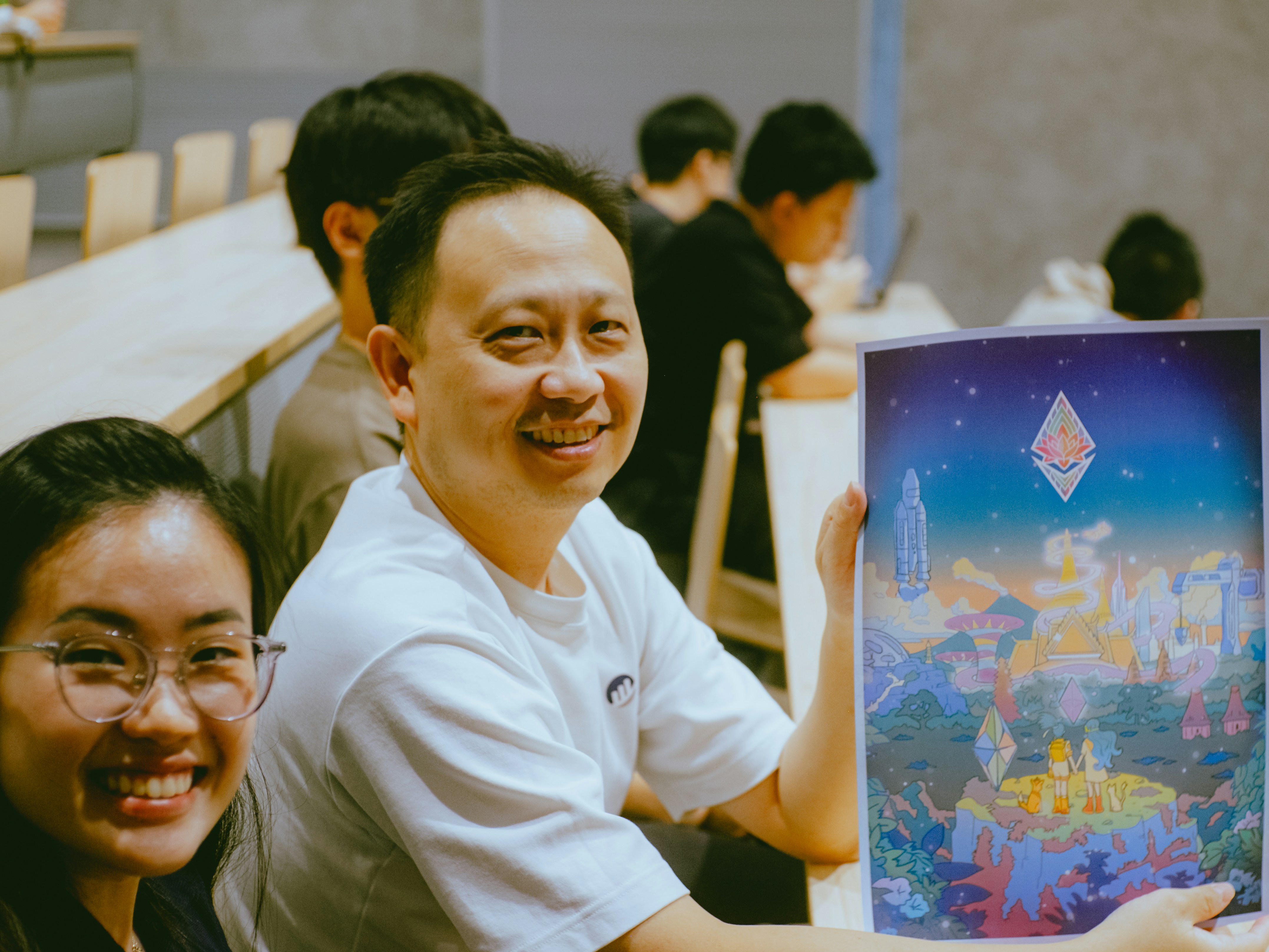 A couple of people that are holding up a picture