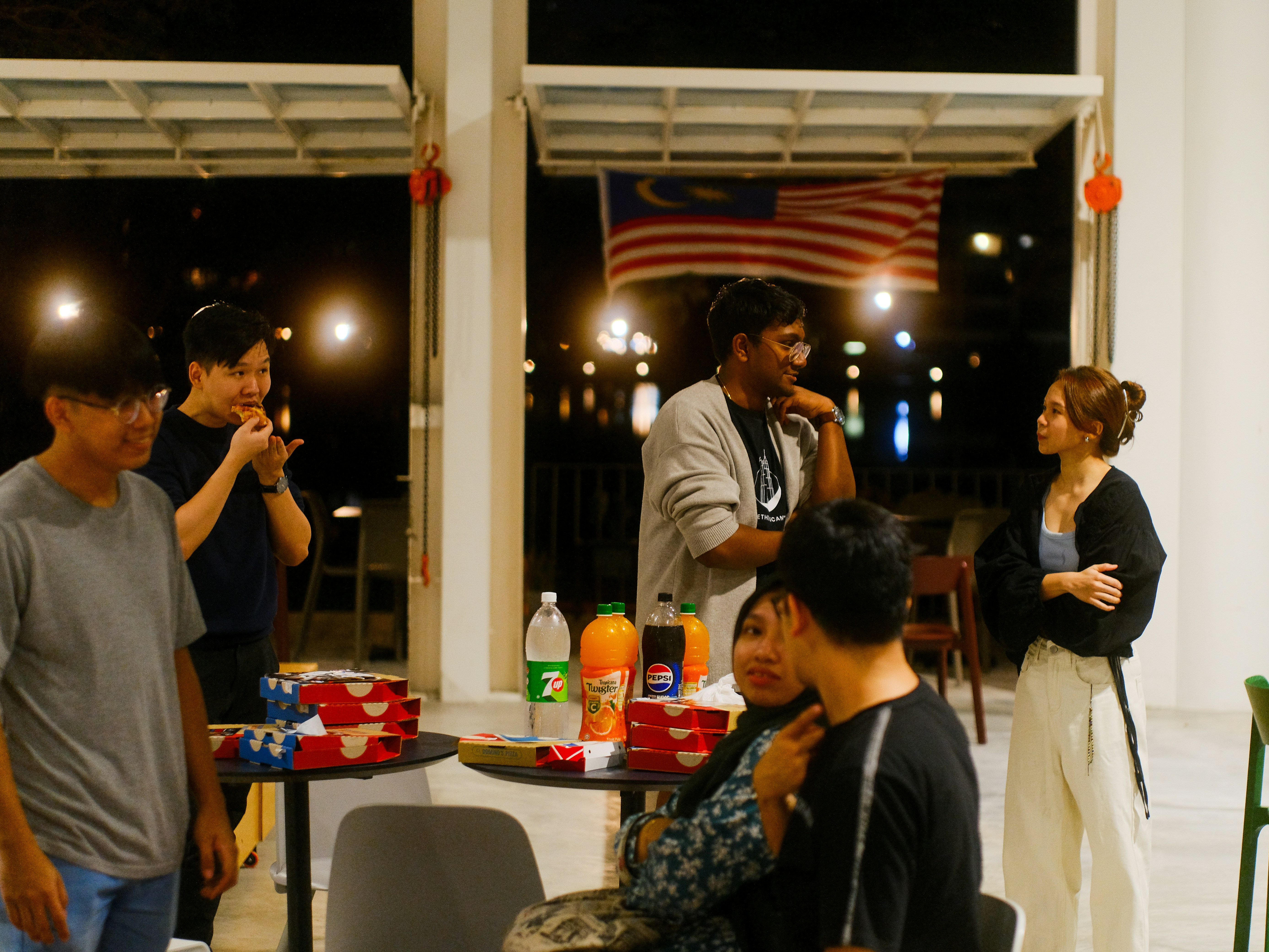 A group of people standing and sitting around a table