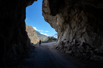 A person is standing in the middle of a tunnel