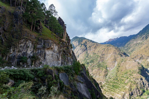 A scenic view of a valley with a mountain in the background