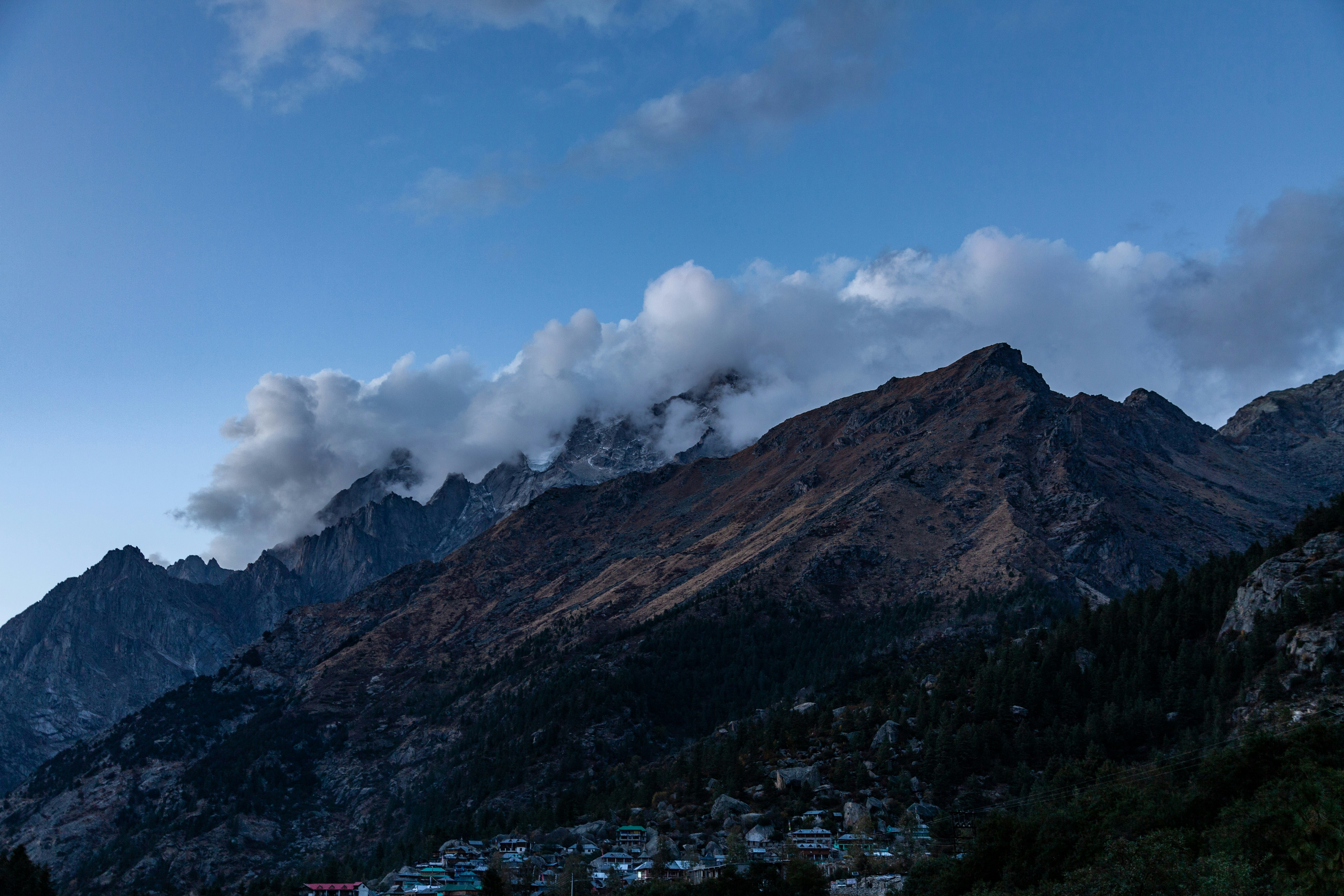 A view of a mountain range with clouds in the sky