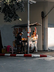 A man standing next to a woman on a street