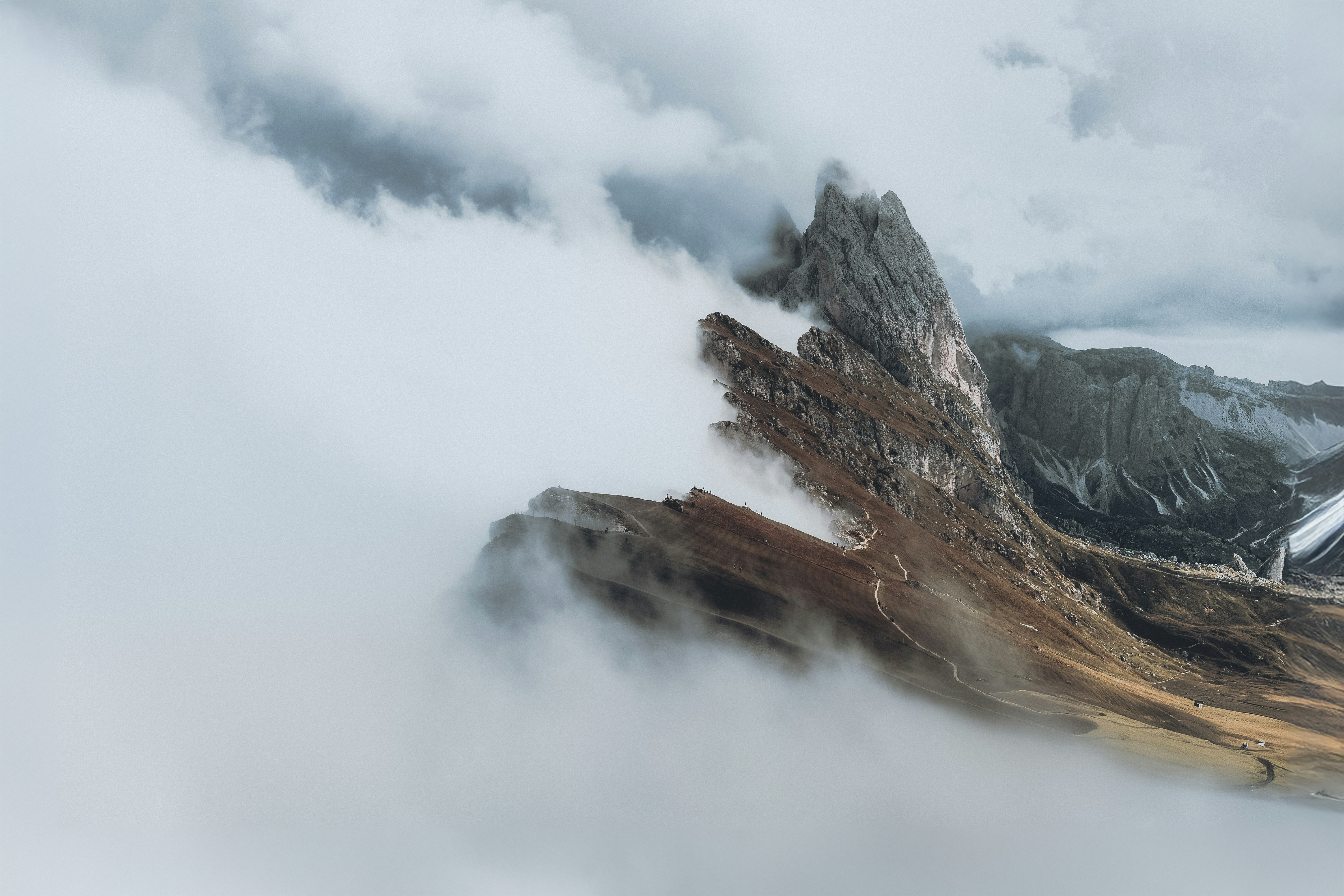 A mountain covered in clouds and snow on a cloudy day