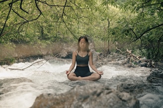 A woman sitting in a river meditating