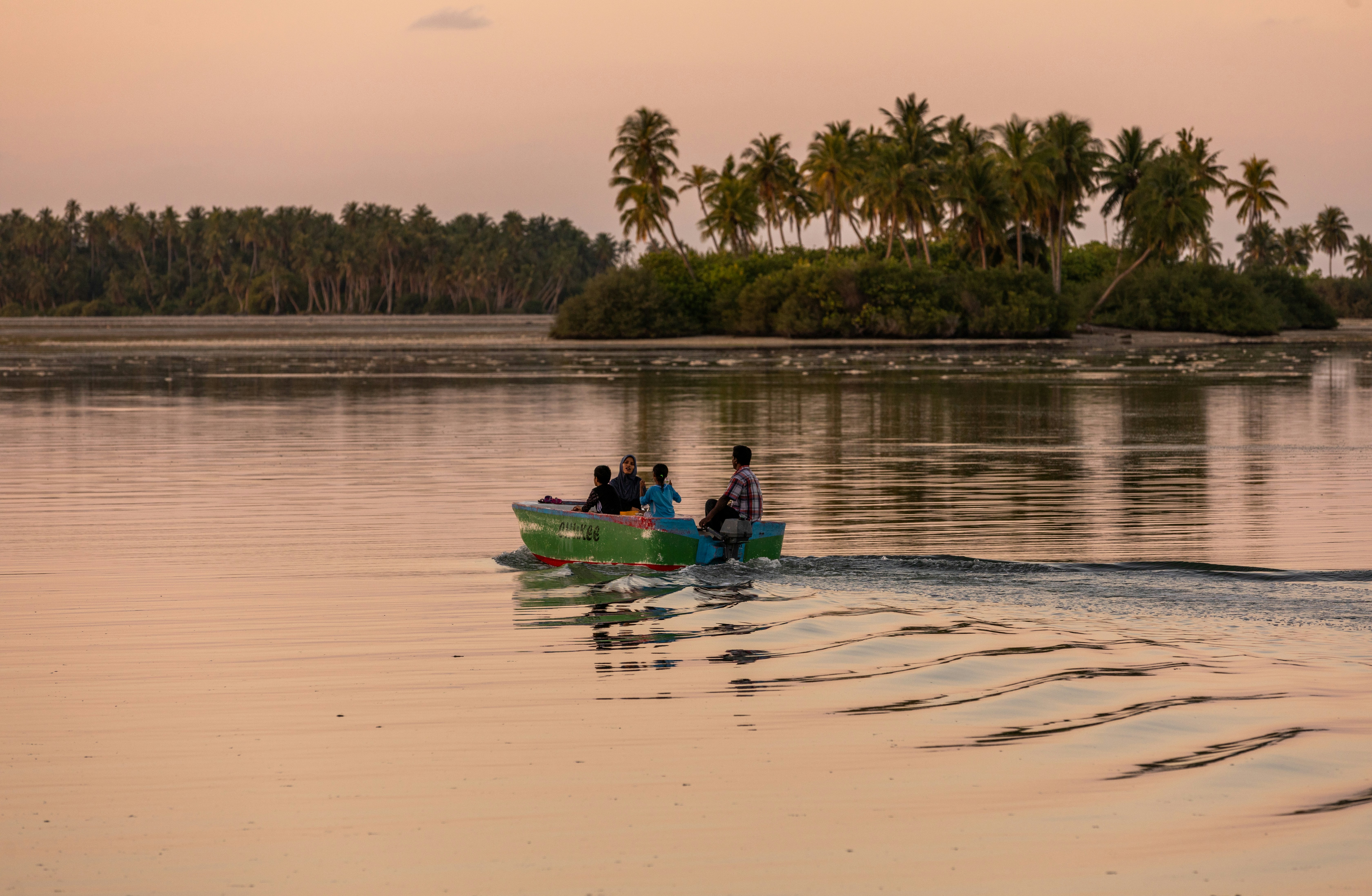 A group of people in a small boat on a lake