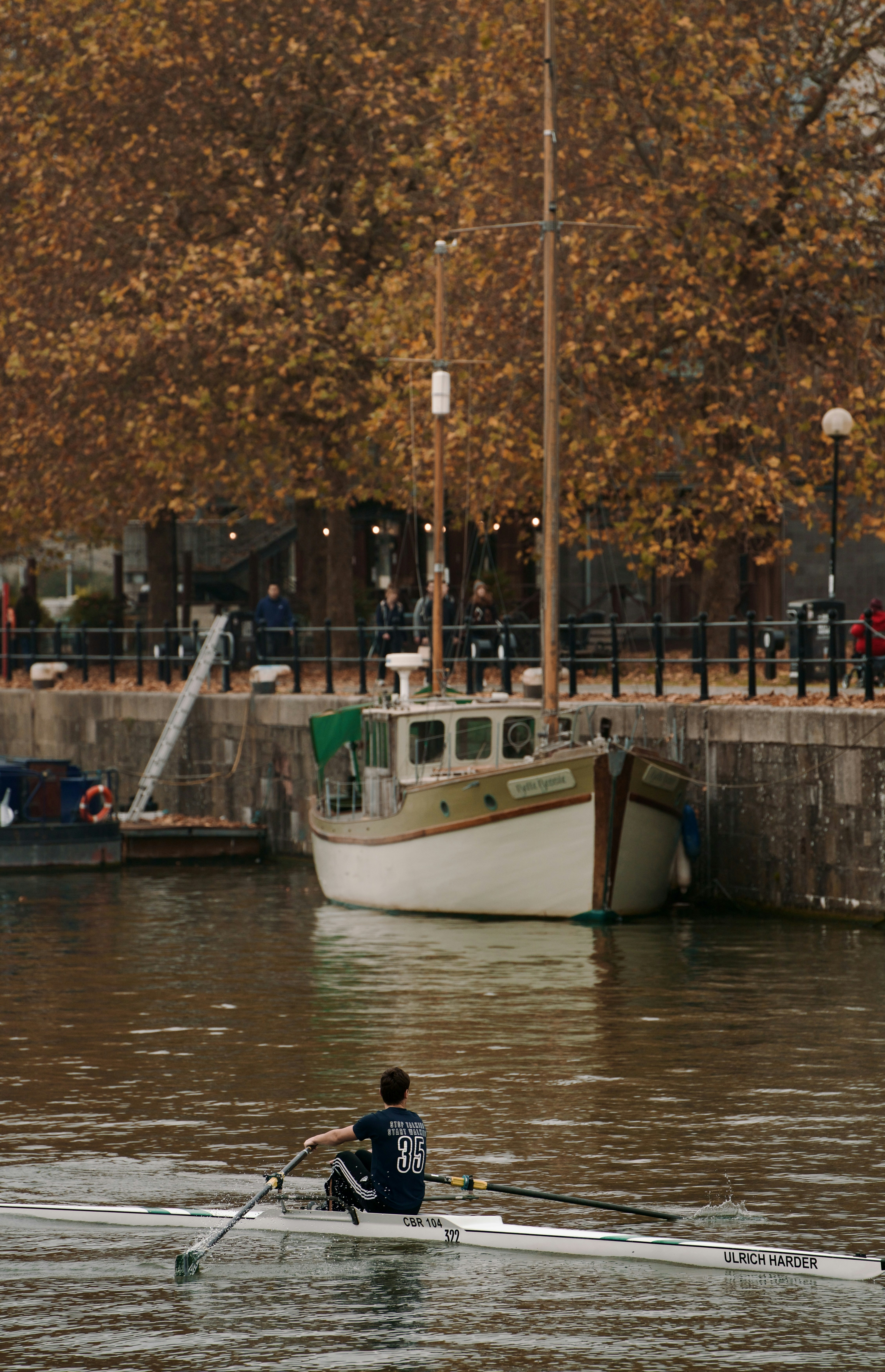 A man rowing a boat on a body of water