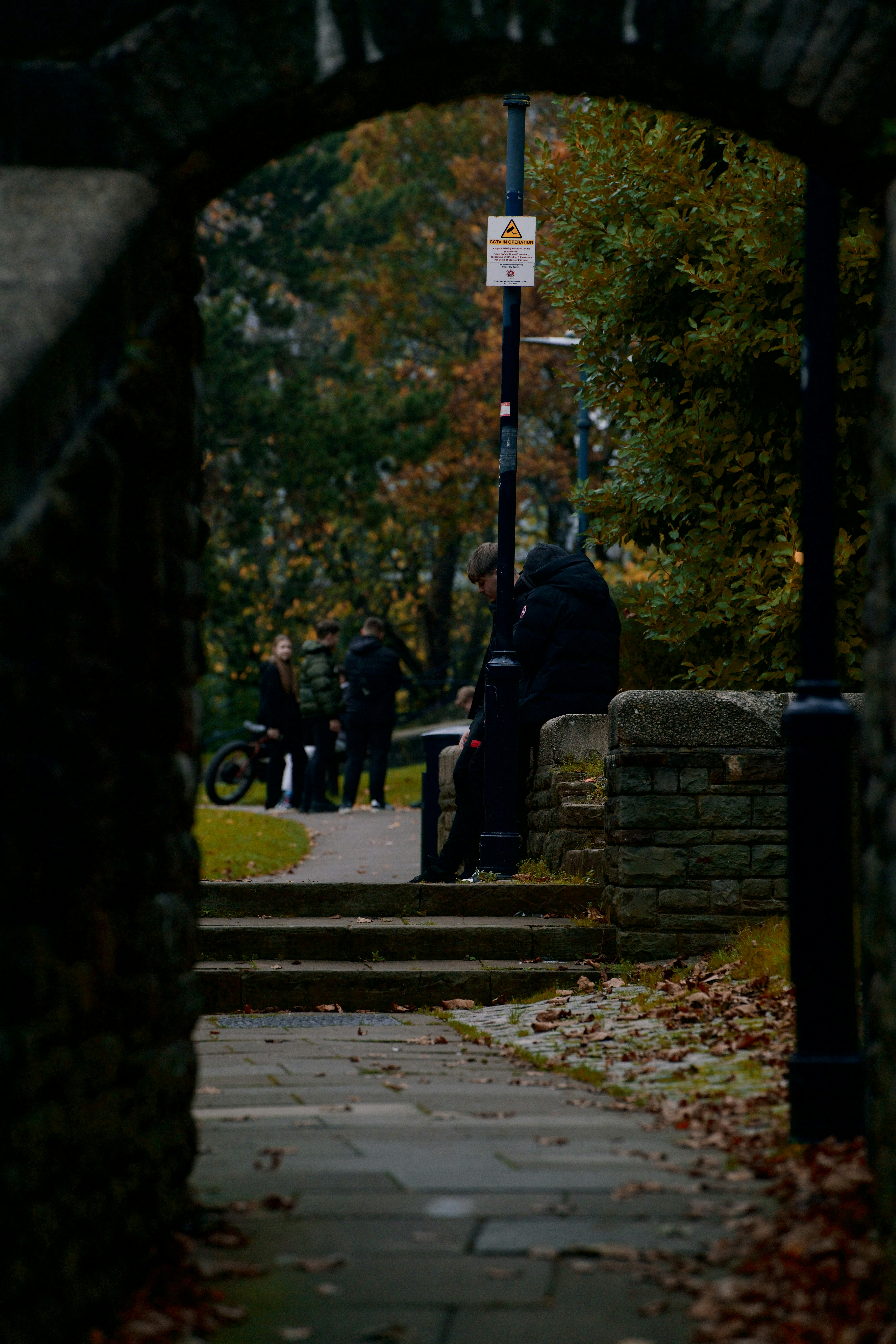 A group of people walking down a sidewalk