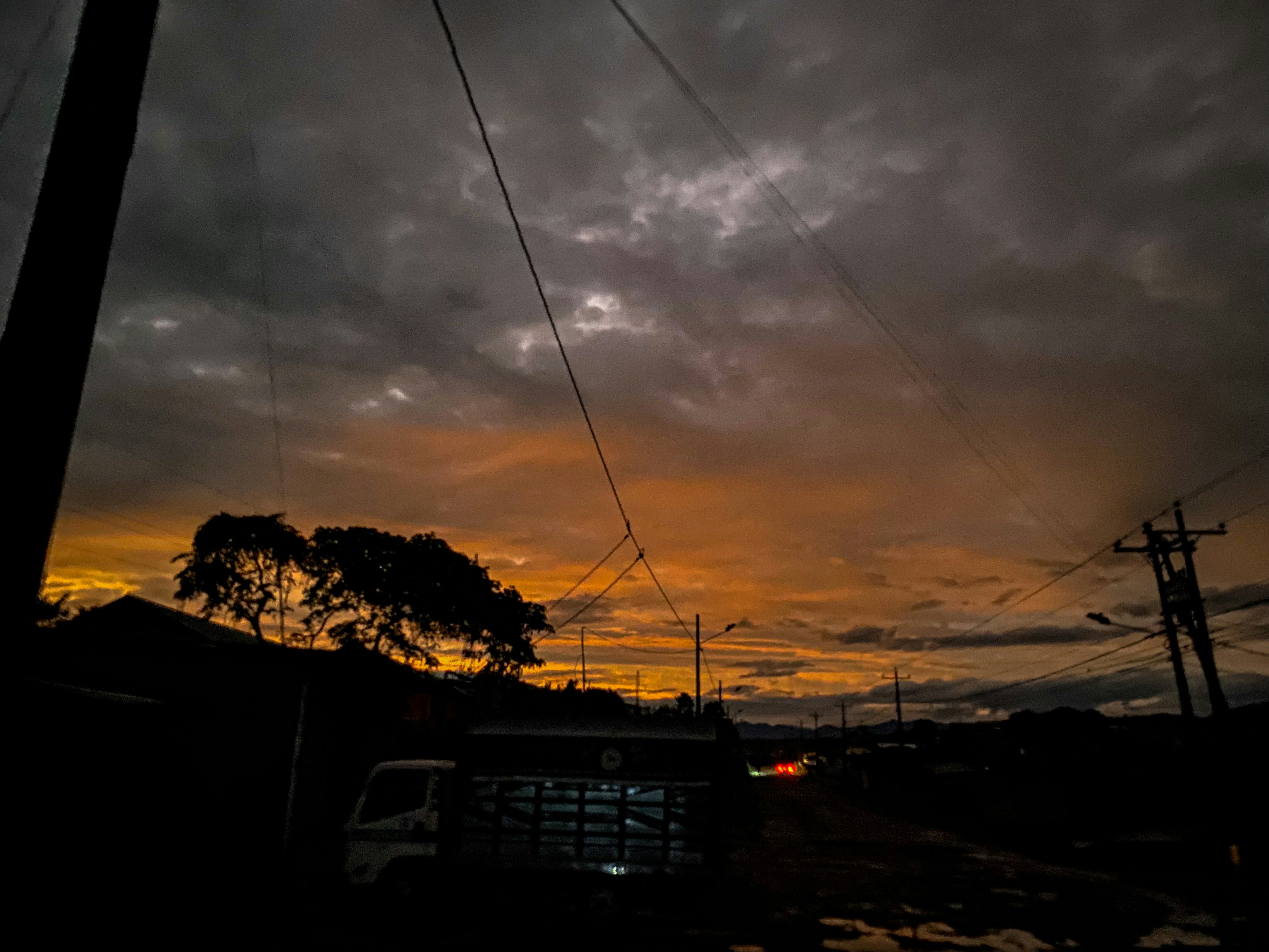 Performance truck on open road, dark dramatic sky, low-key cinematic lighting
