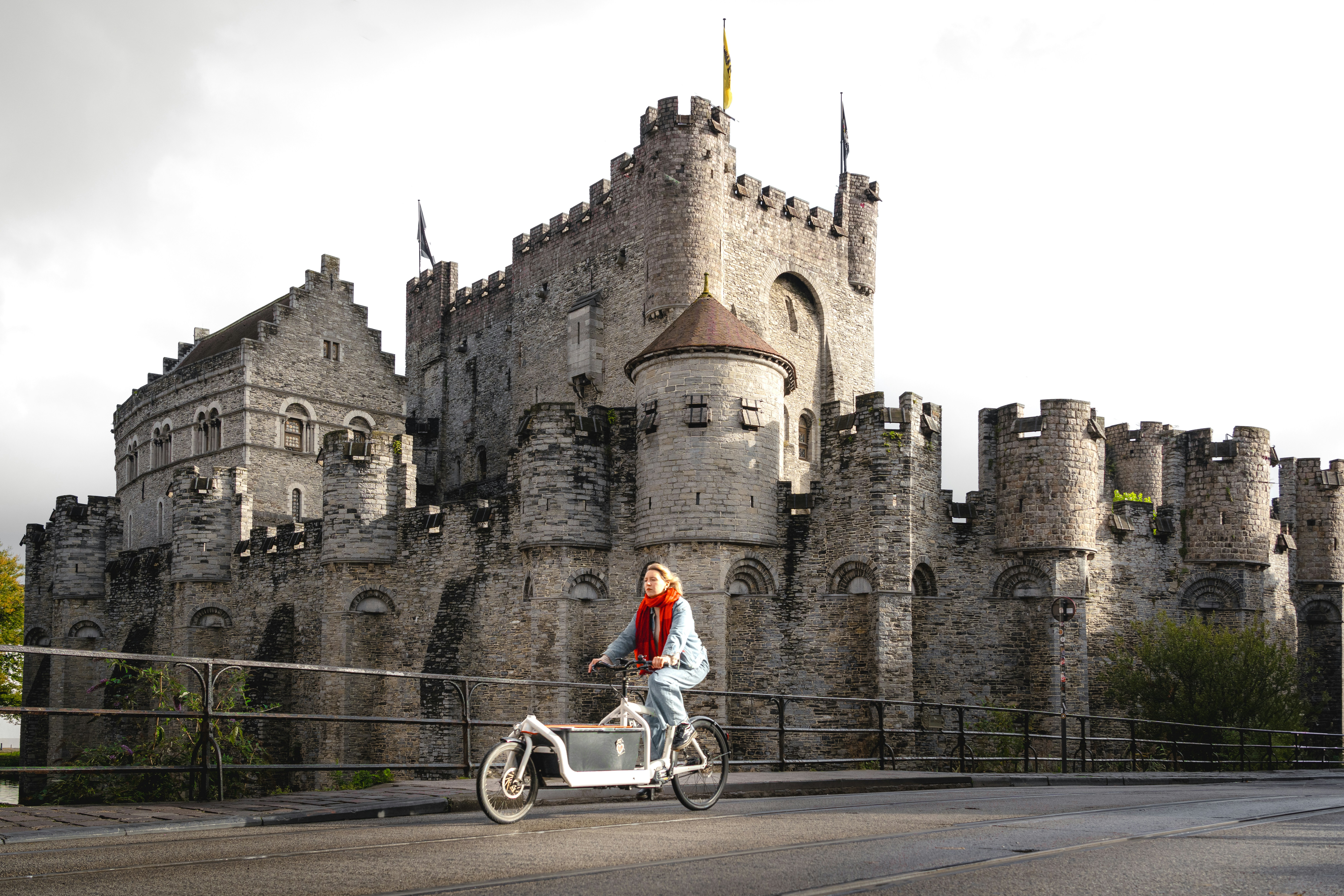 A person riding a bike in front of a castle