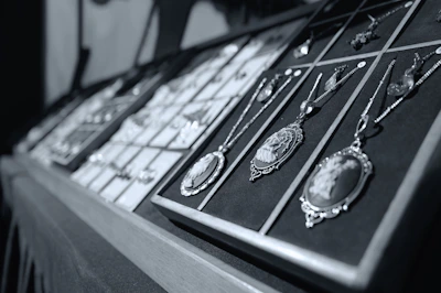 A computer keyboard with a bunch of necklaces on it