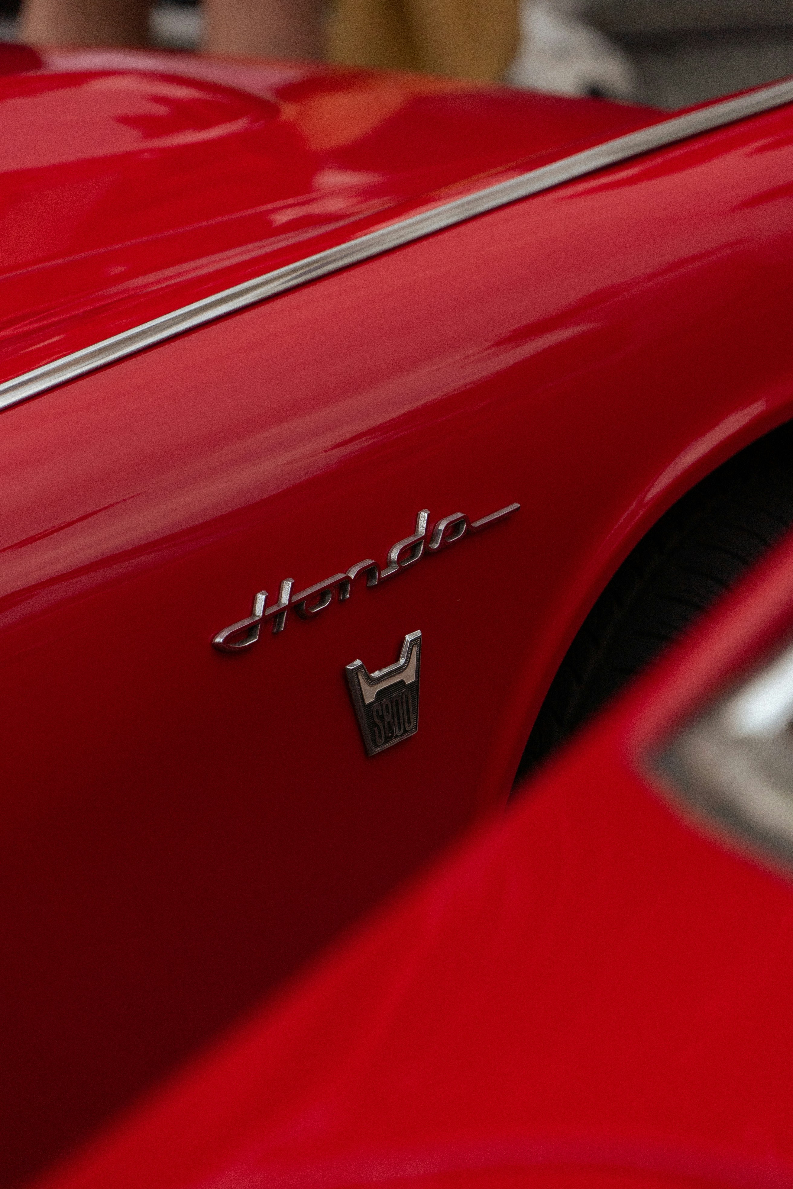 A close up of the hood of a red sports car