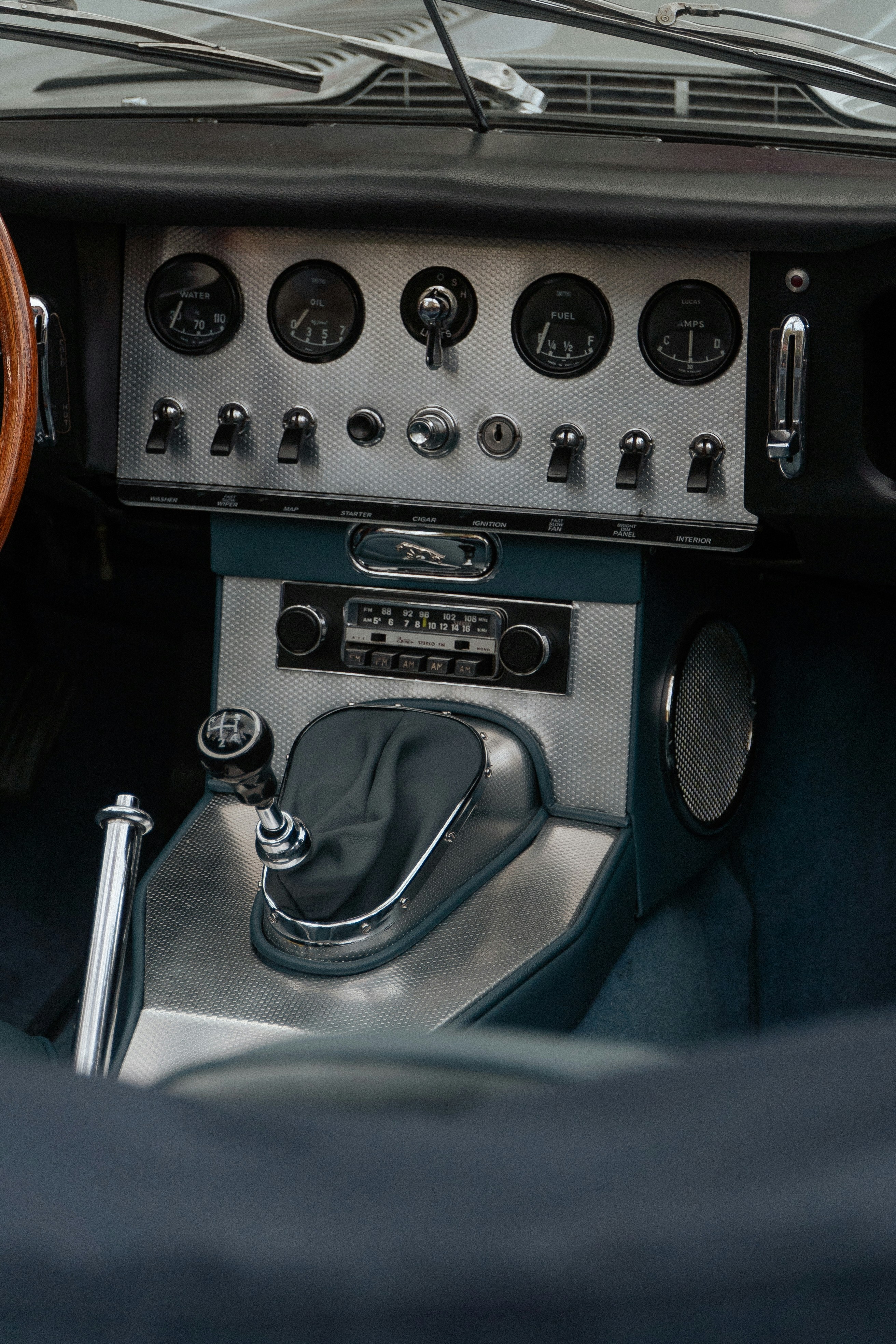 A car dashboard with a steering wheel and a dash board