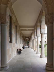 A long hallway lined with columns and benches