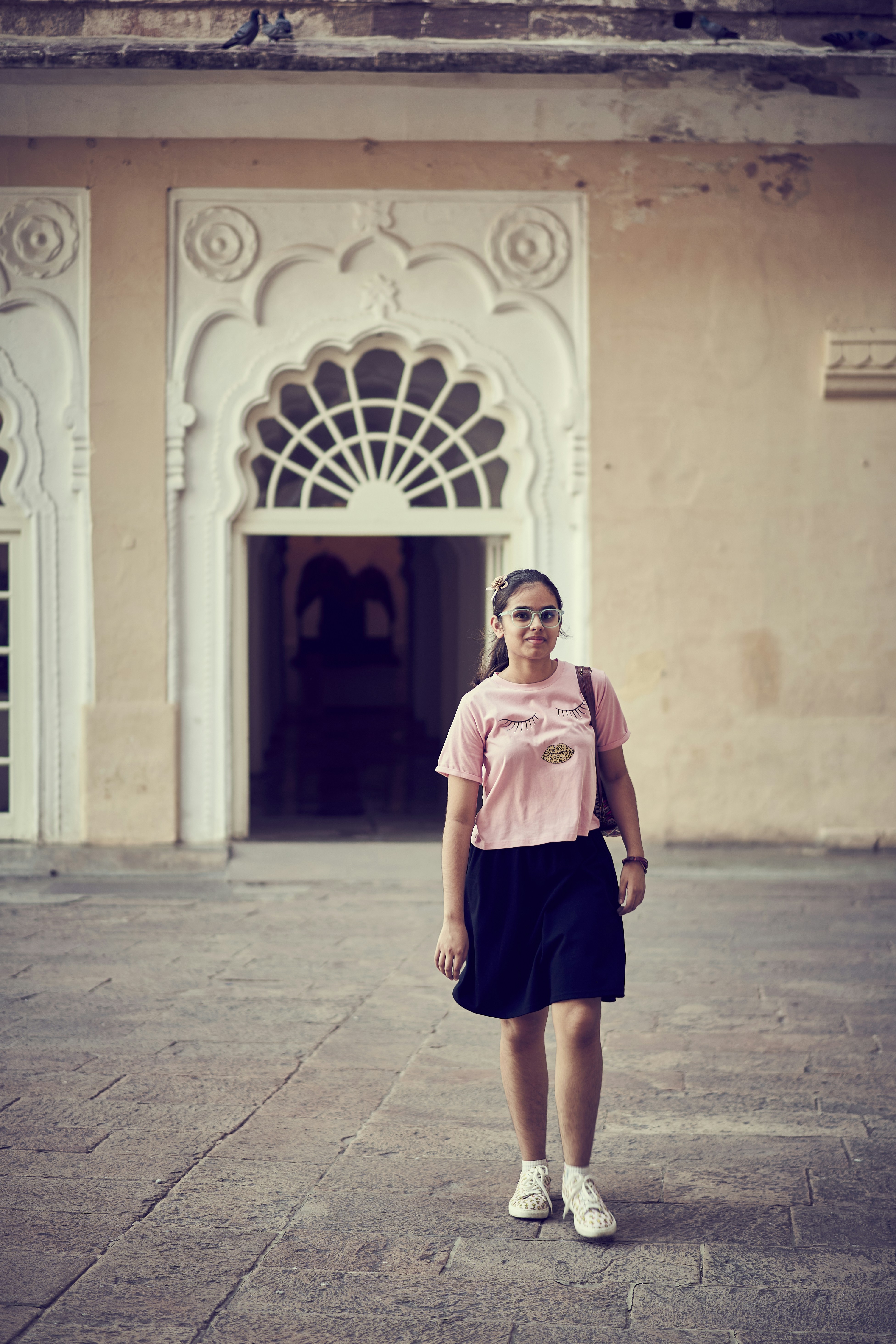 A woman standing in front of a building
