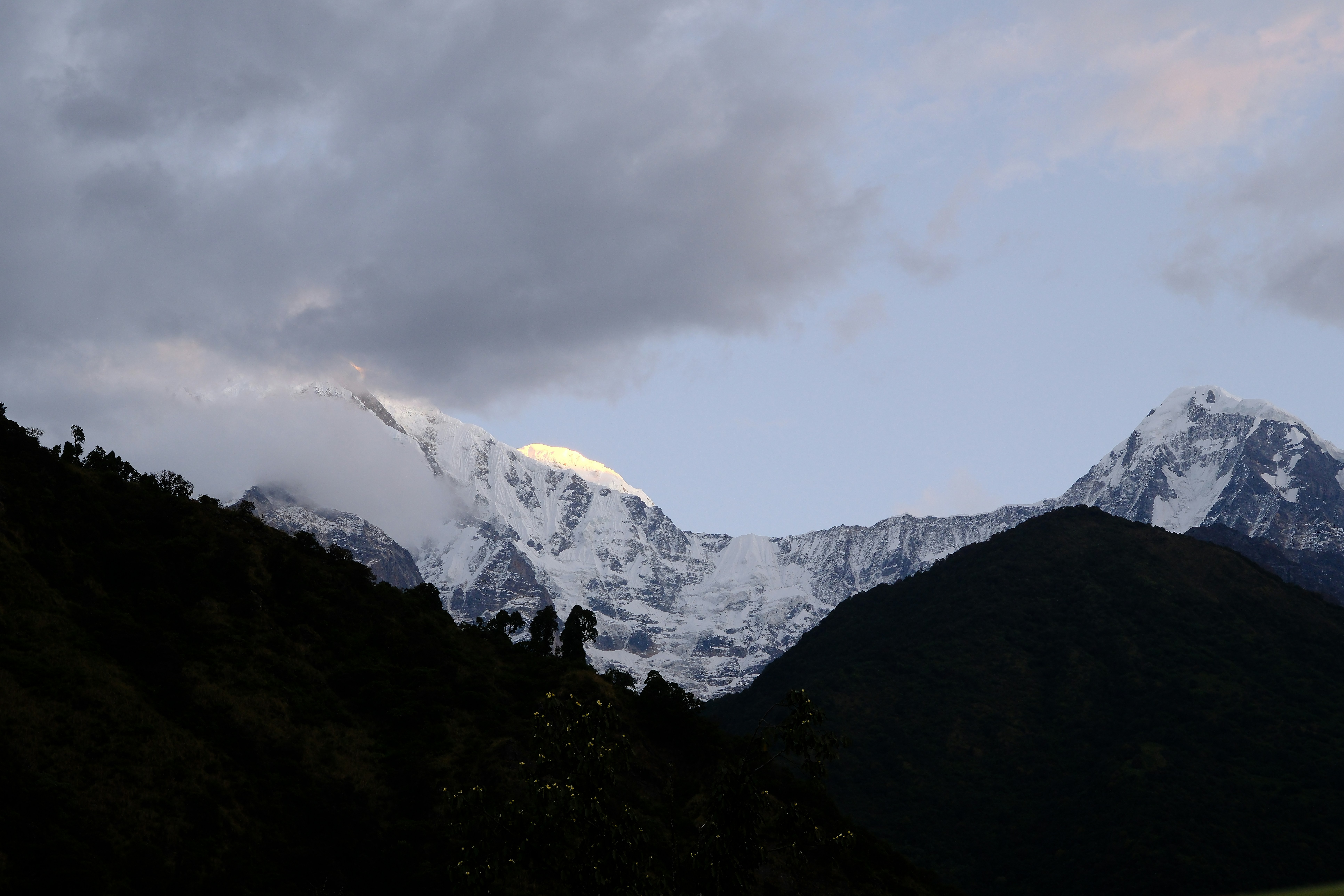 A view of a mountain range with clouds in the sky
