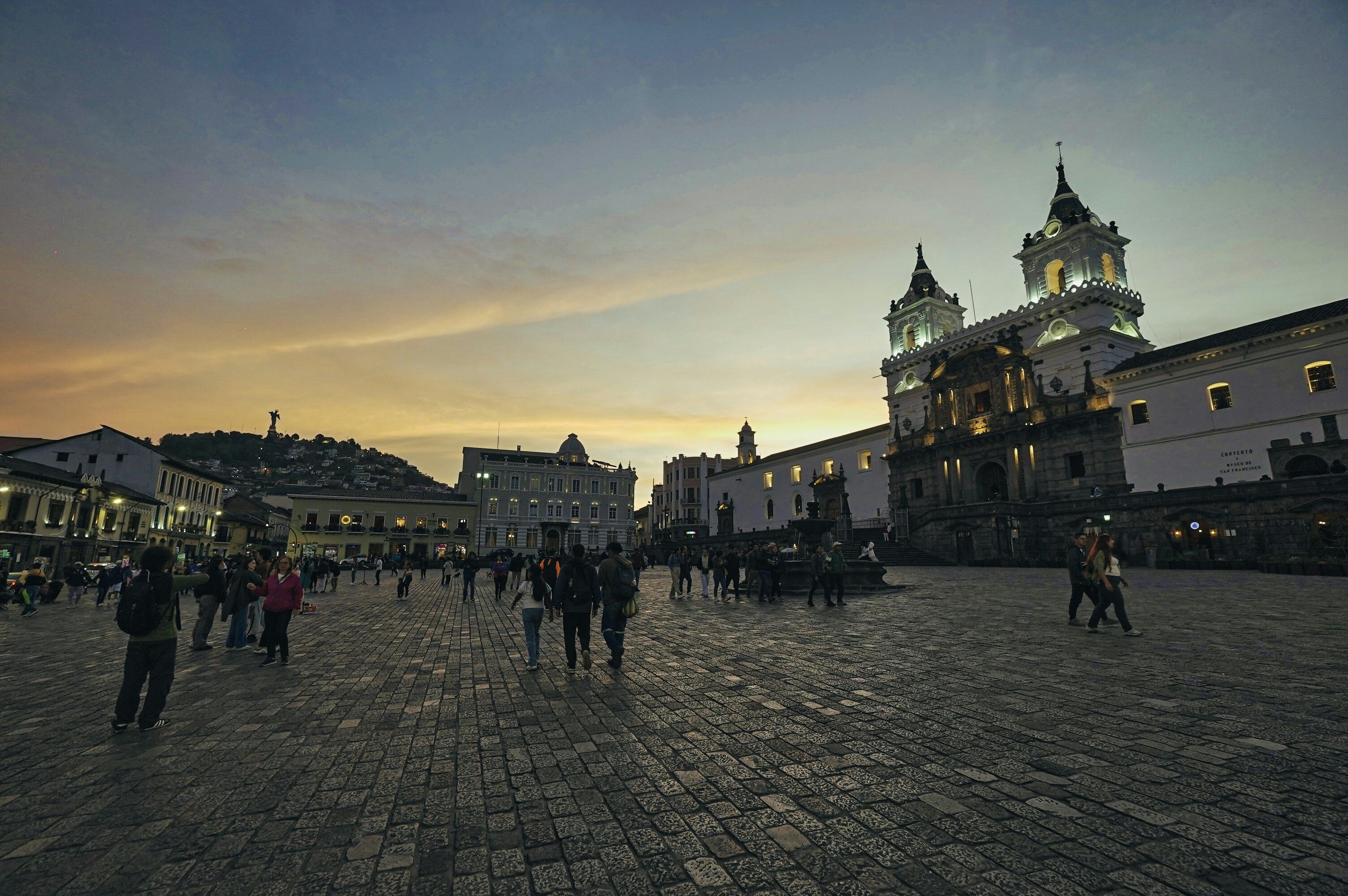 A group of people walking around a city square