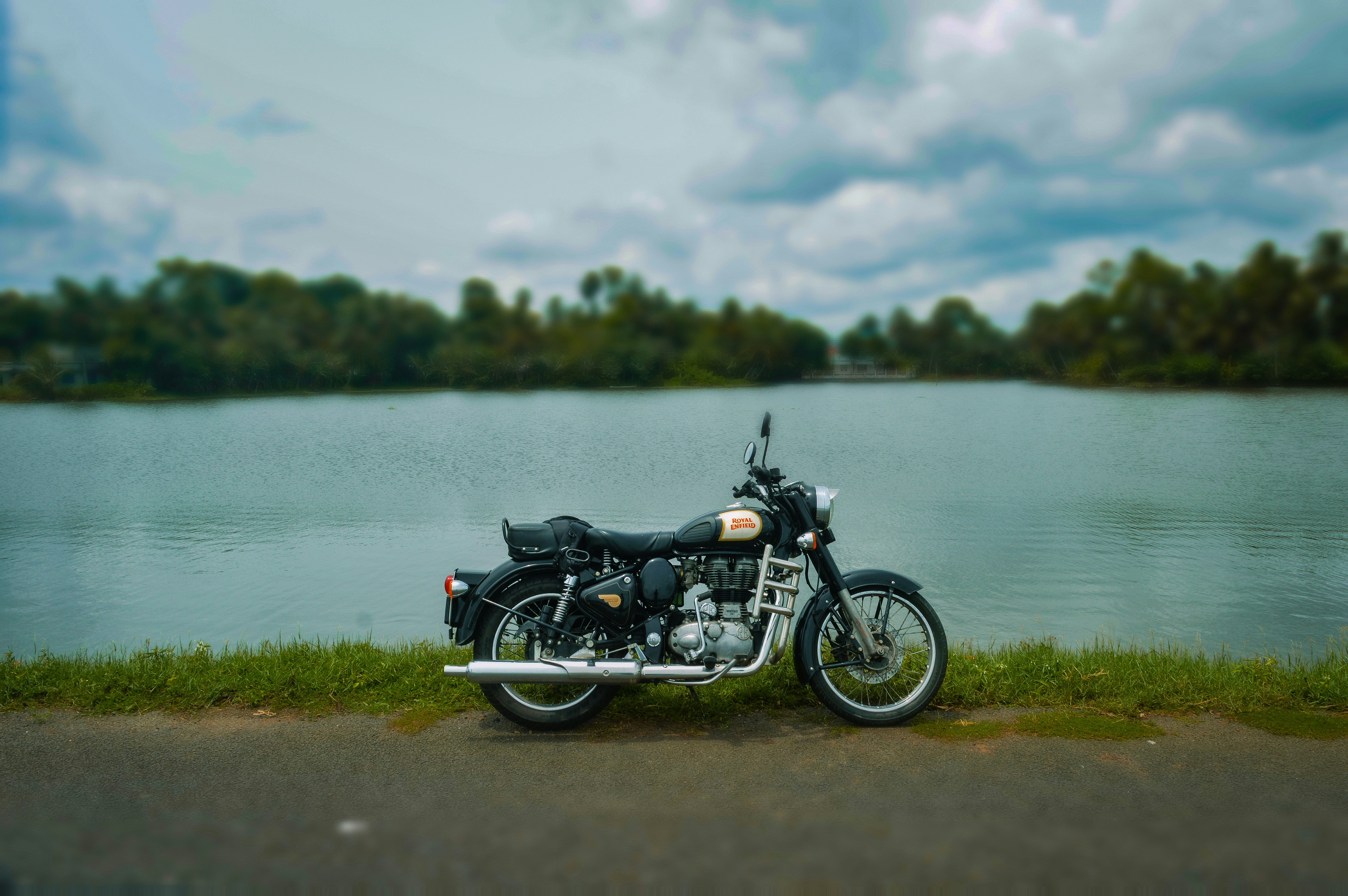 A motorcycle parked next to a body of water