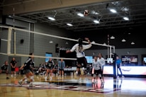 A group of people playing a game of volleyball