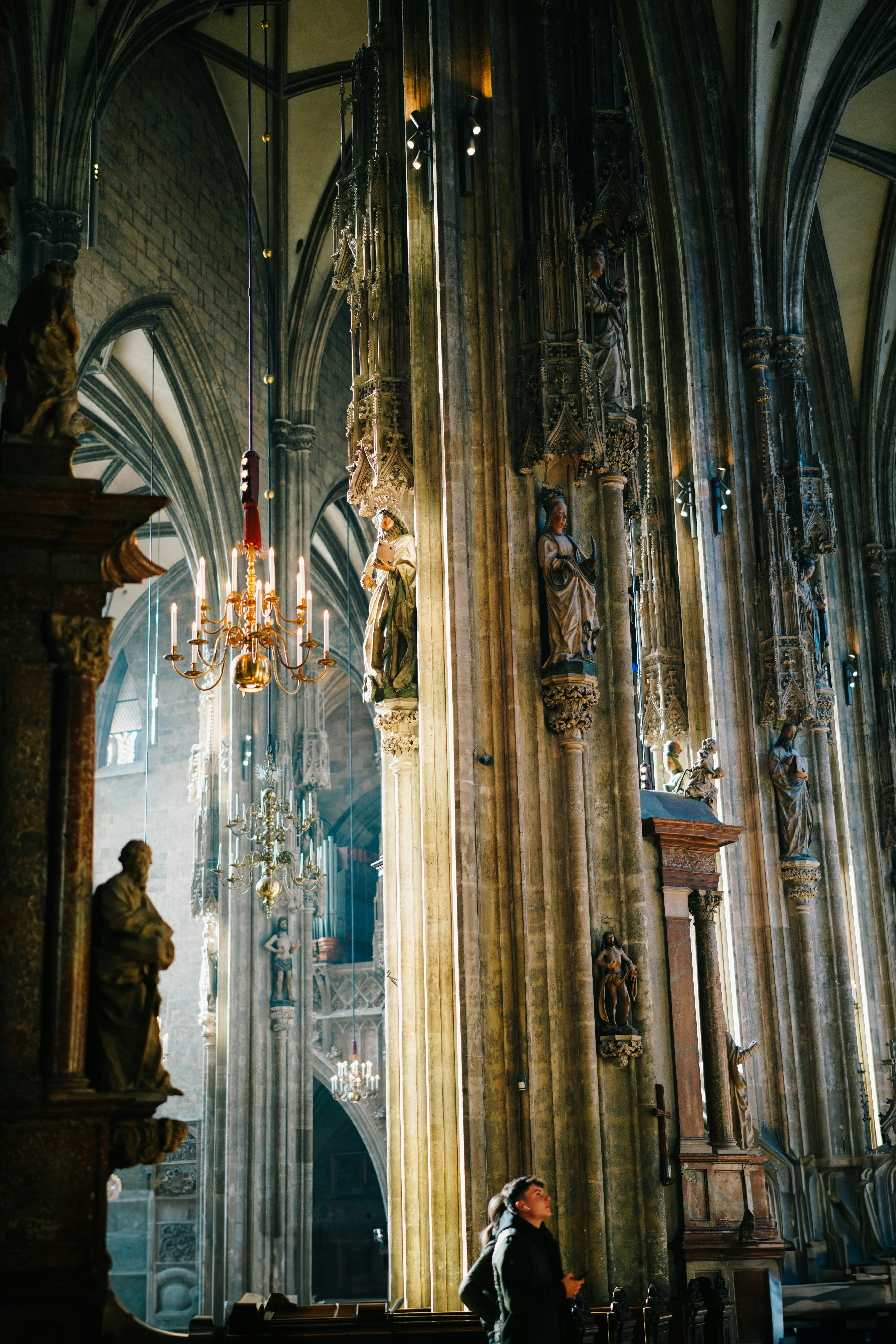 A person standing in front of a tall cathedral