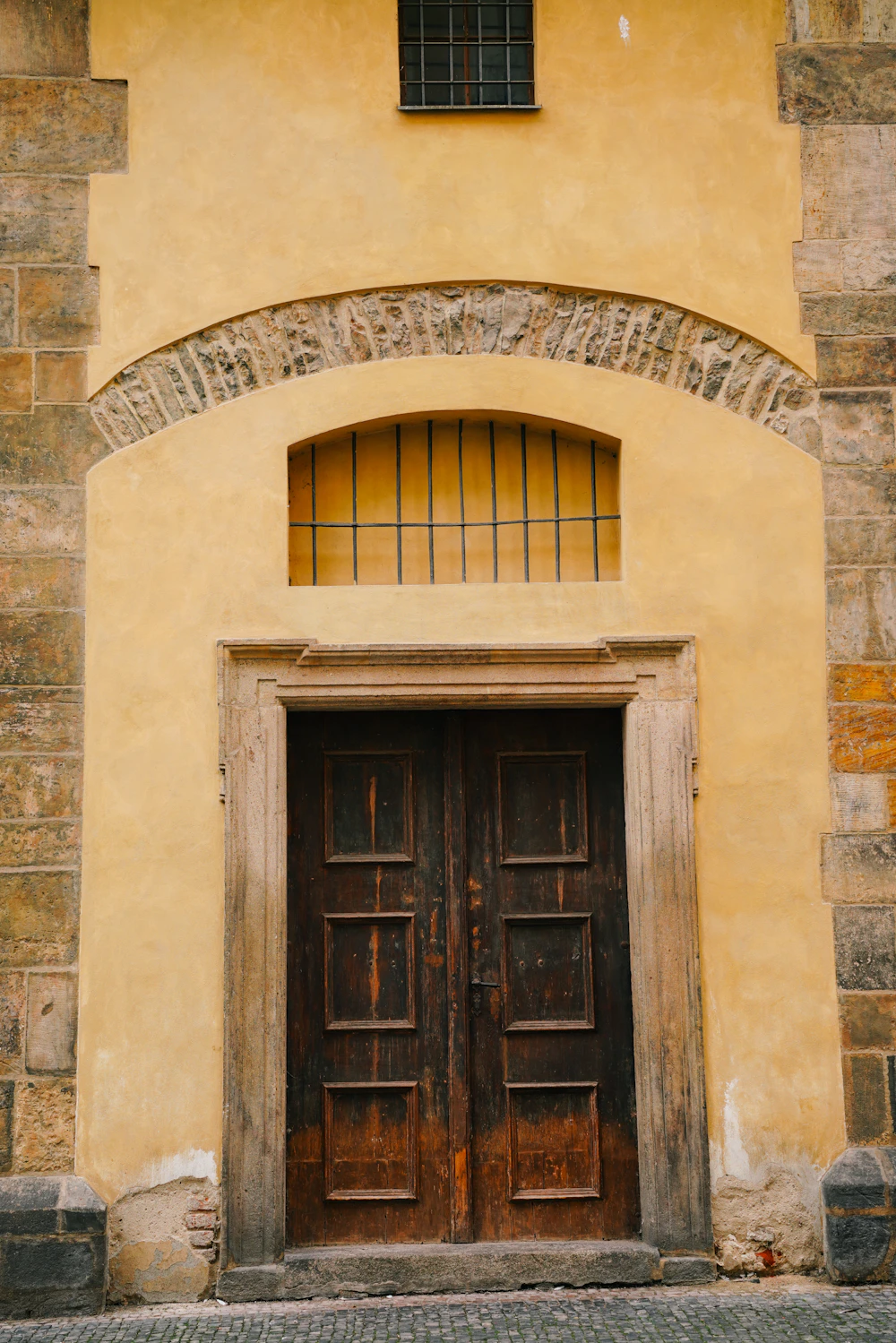 Old wooden door and window set in a building, a reminder of how timber doors age without proper sealing