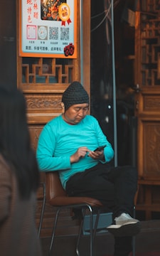 Woman at gym checking phone progress