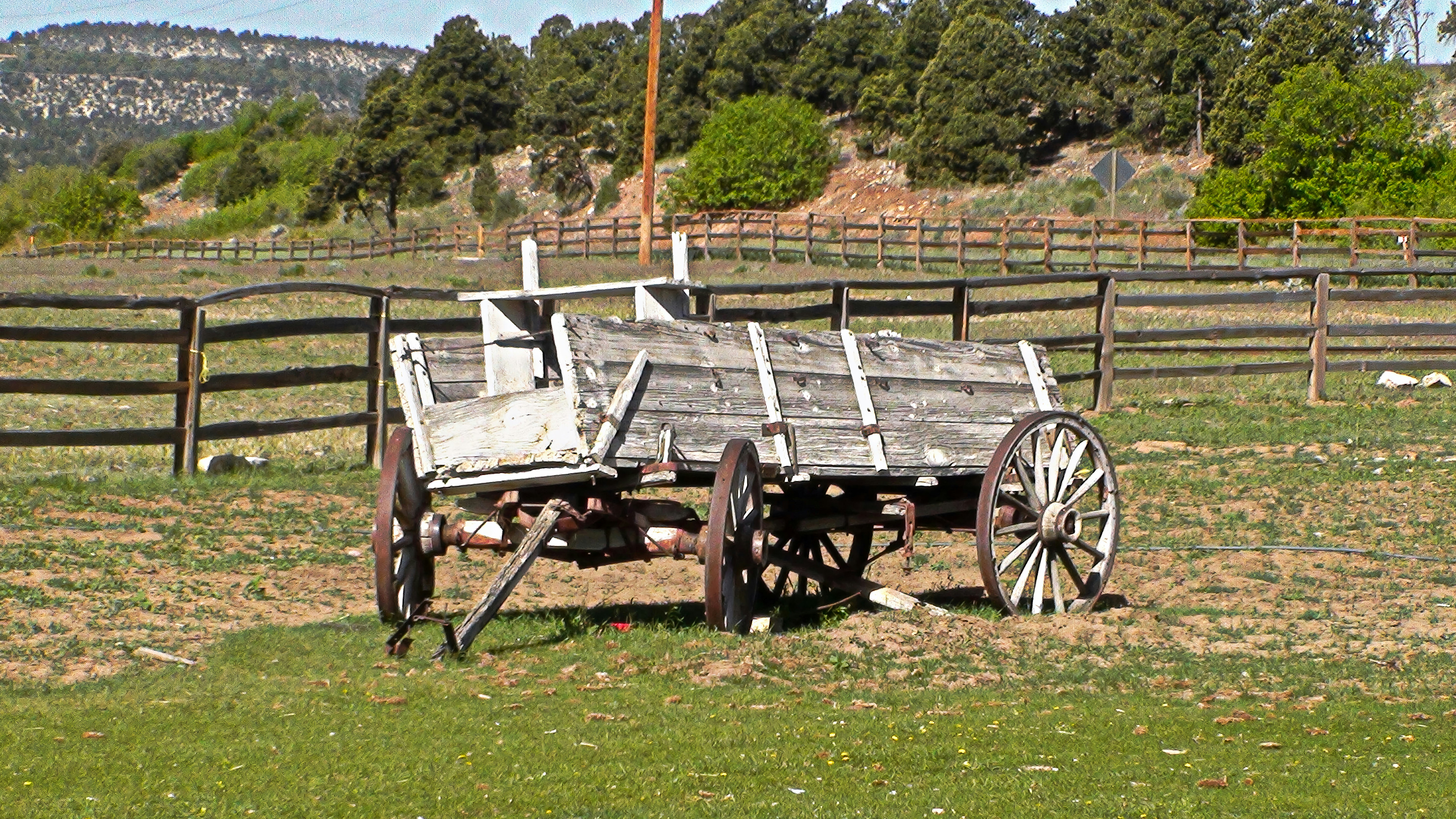 An old wooden wagon sitting in a field