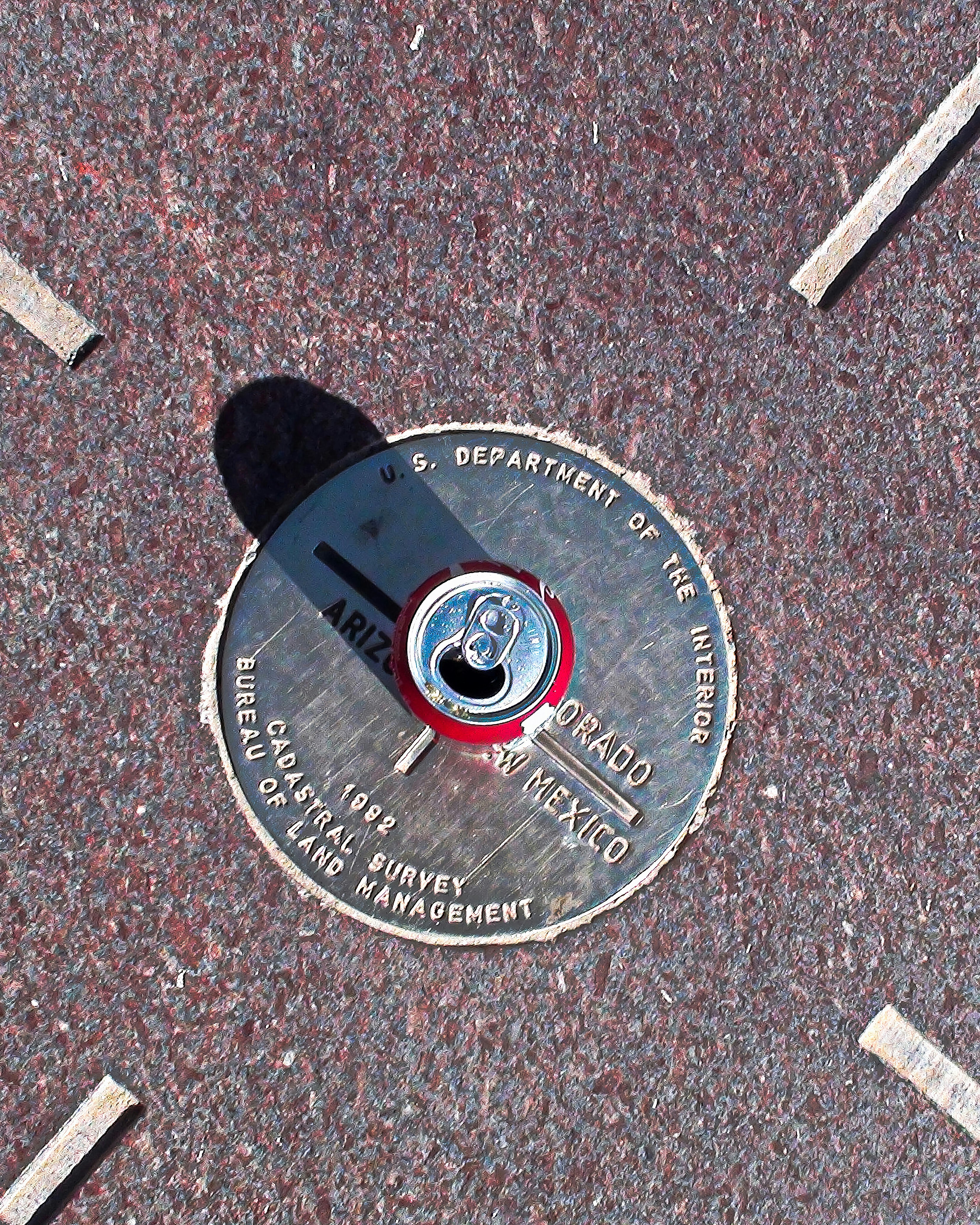 A fire hydrant with a can of soda on top of it