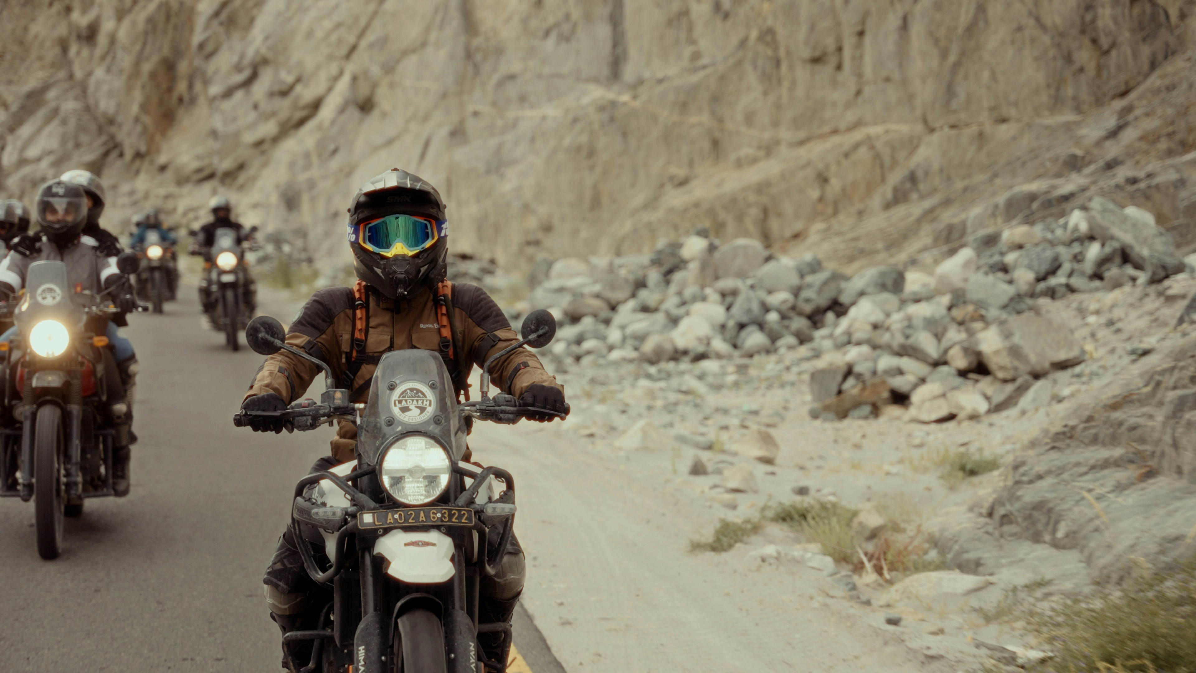 A group of people riding motorcycles down a road photo – Free Green ...