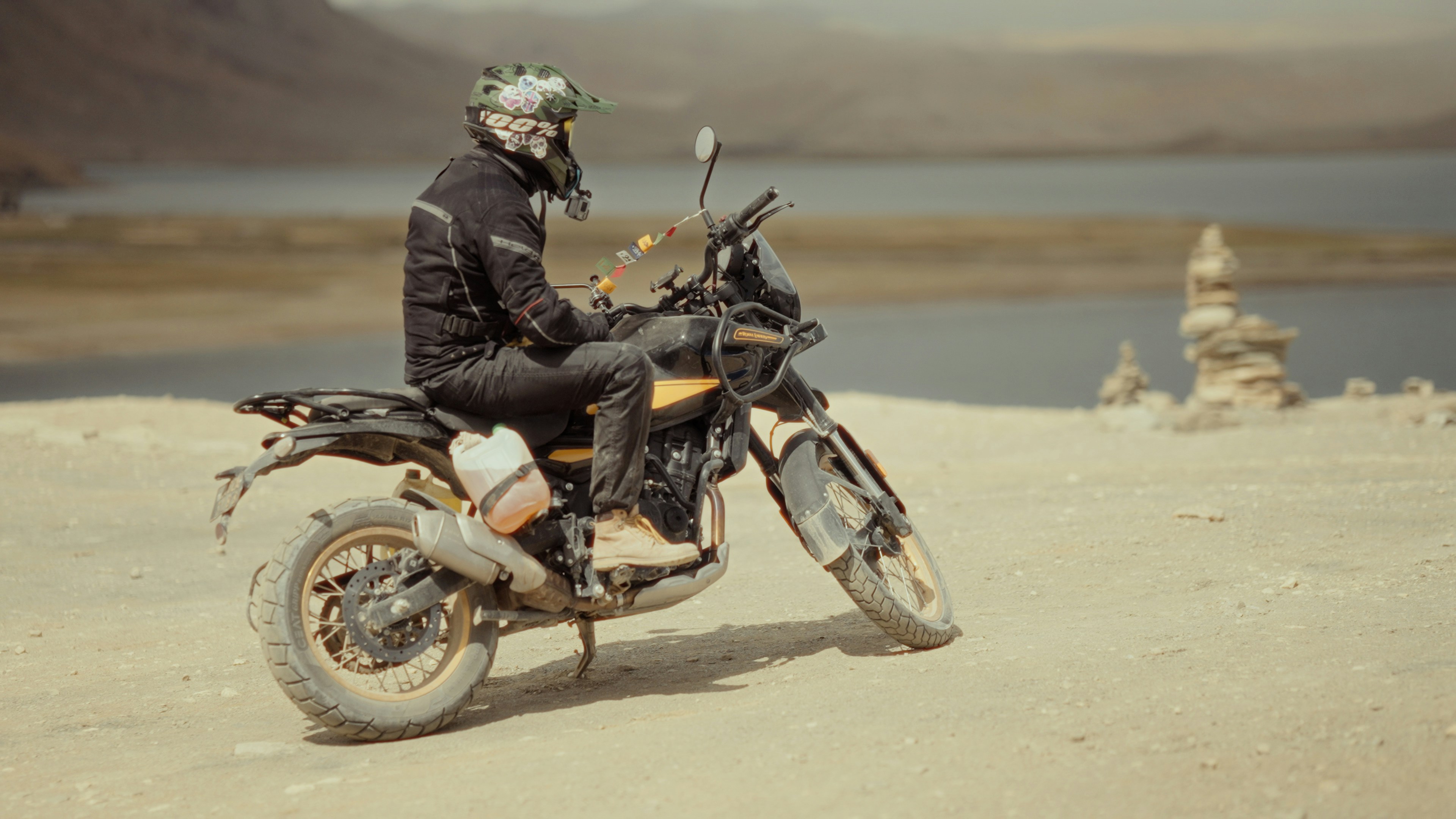 A man sitting on a motorcycle in the desert
