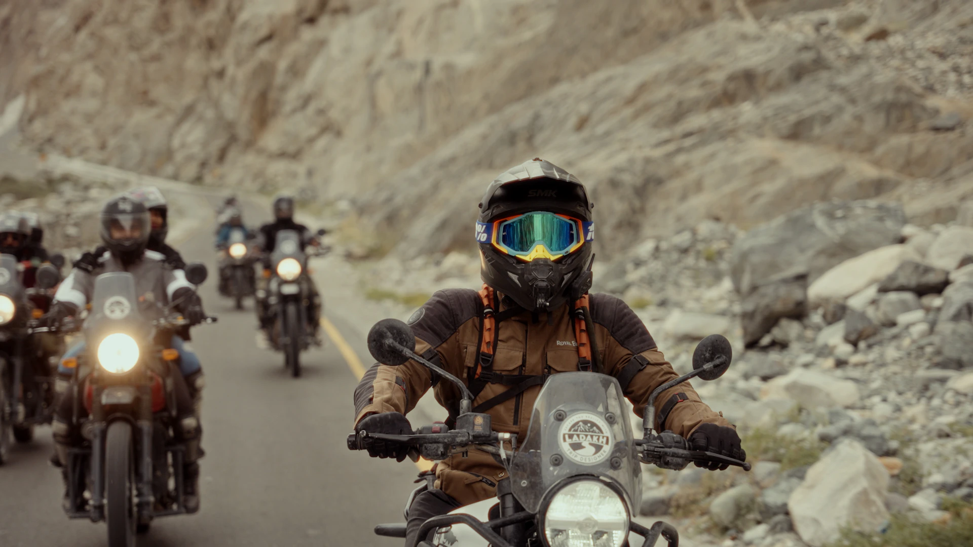 A group of motorcyclists riding down a mountain road