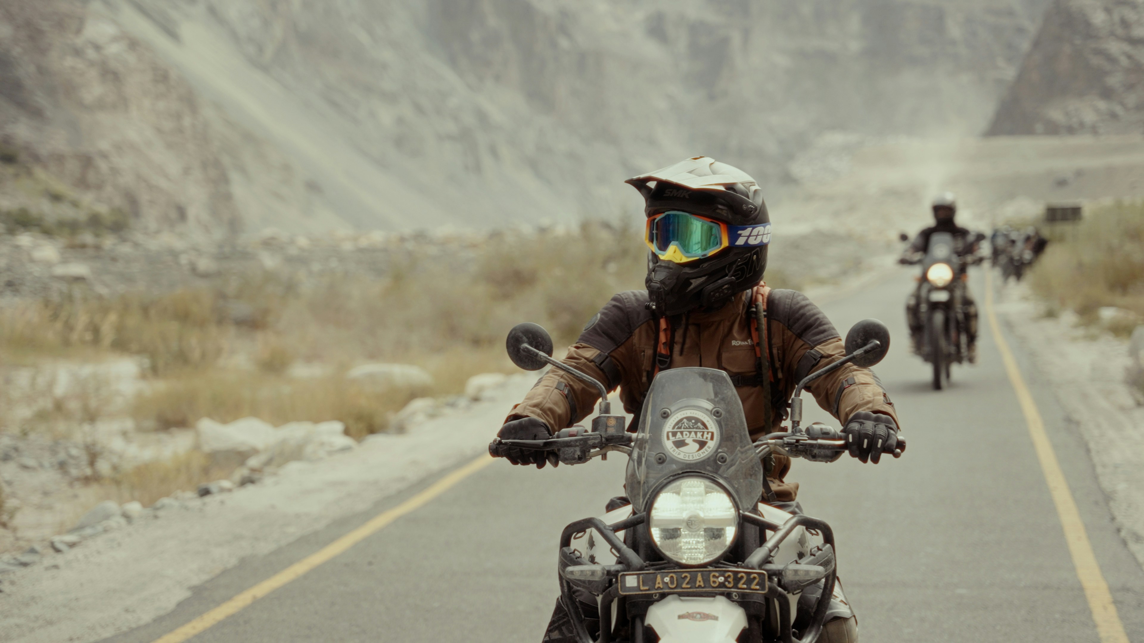 A group of people riding motorcycles down a road