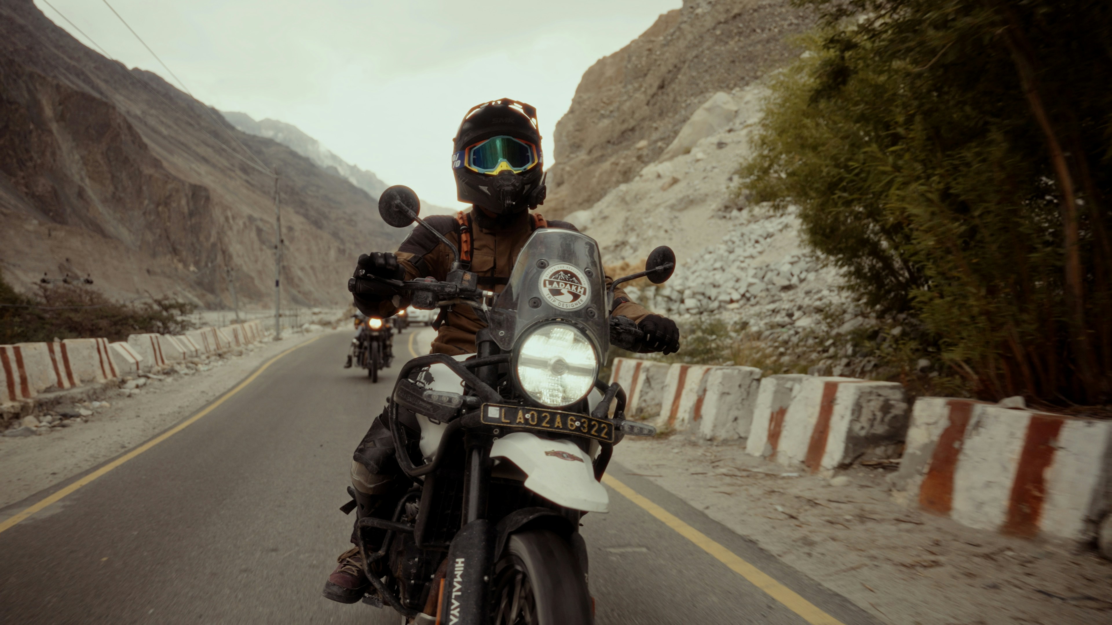 A man riding a motorcycle down a curvy road