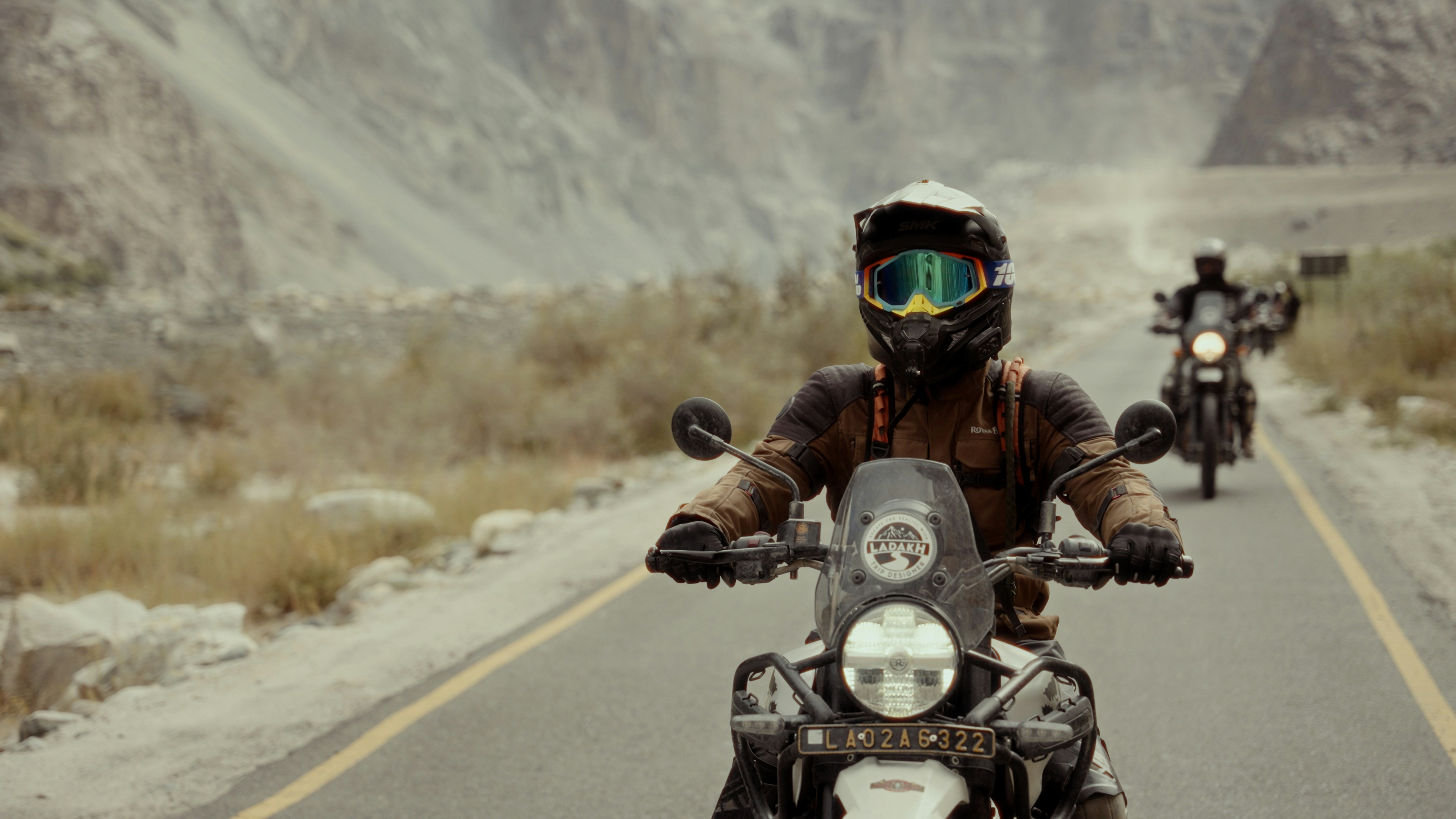 A group of people riding motorcycles down a road