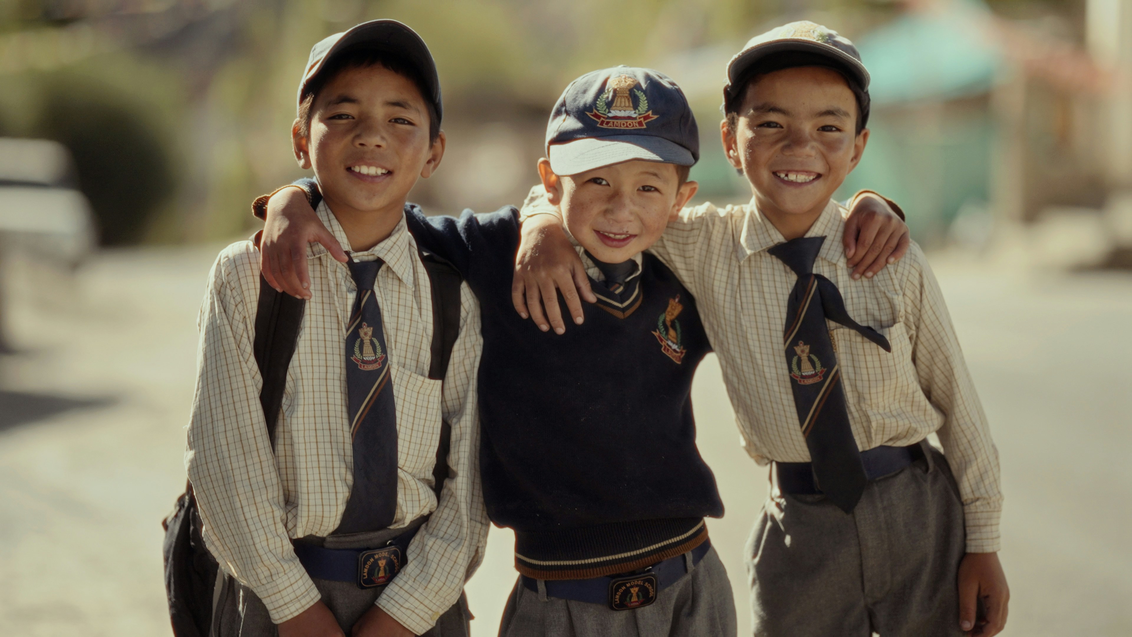 A group of young boys standing next to each other