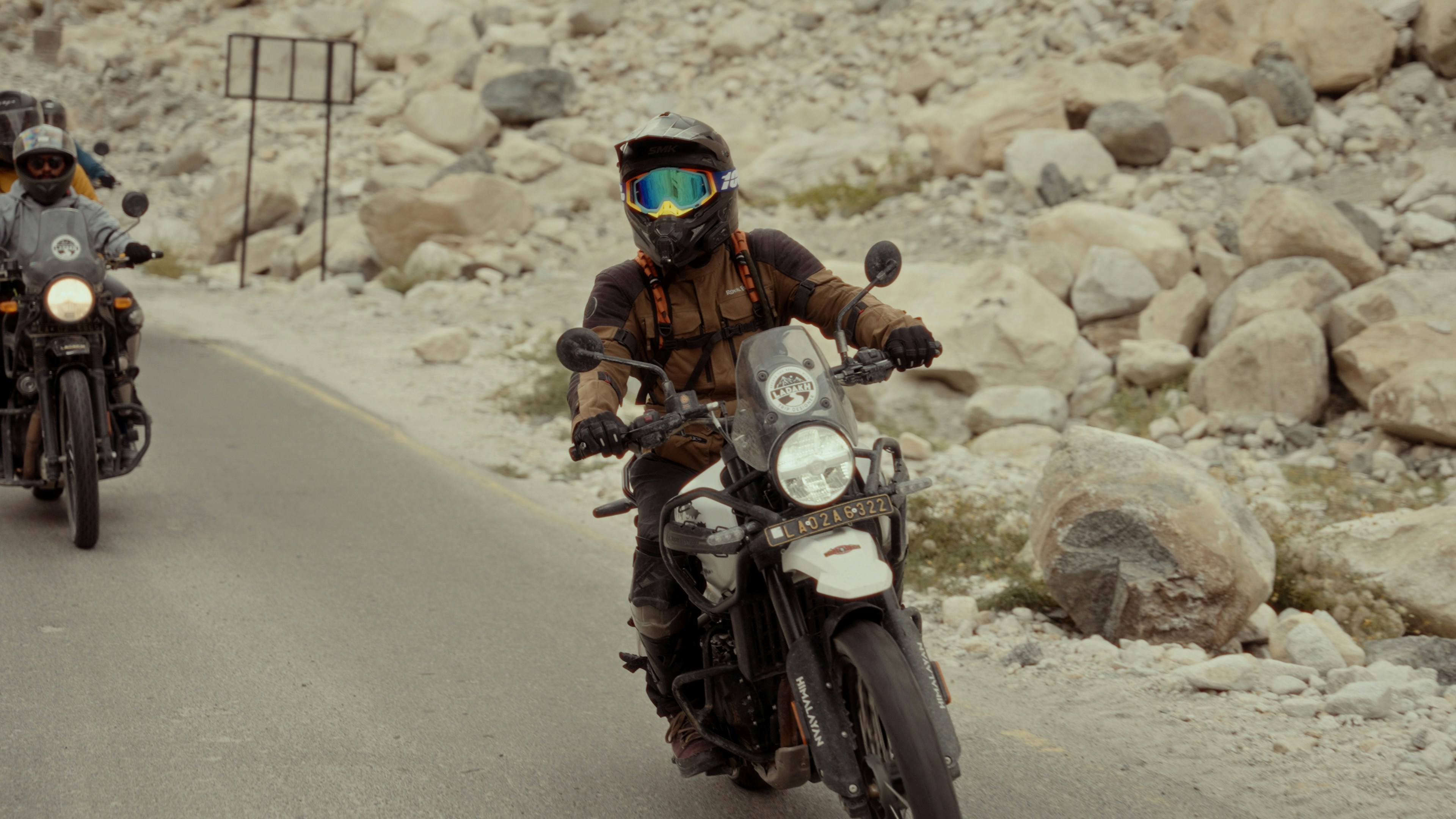 A group of people riding motorcycles down a road