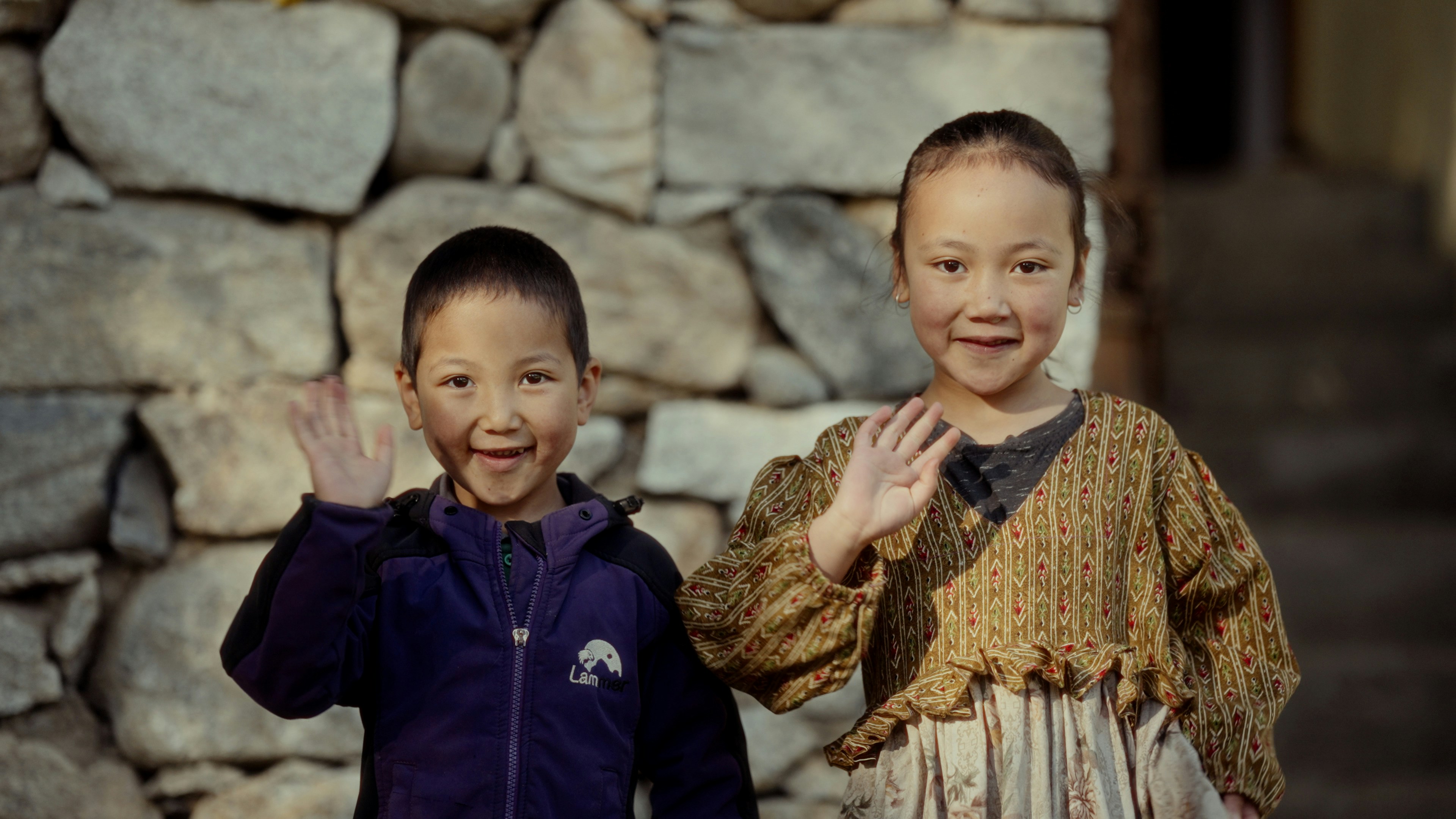 A couple of kids standing next to each other